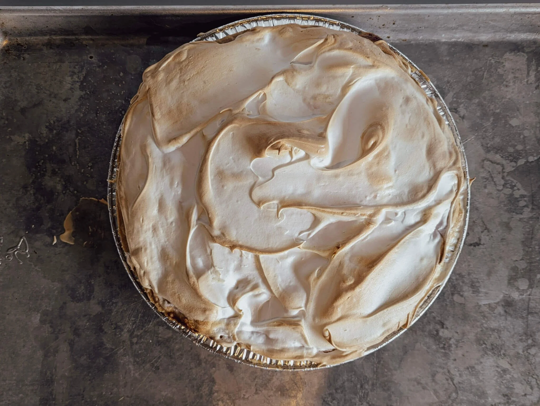 Rhubarb meringue pie with swirled, golden-toasted meringue topping