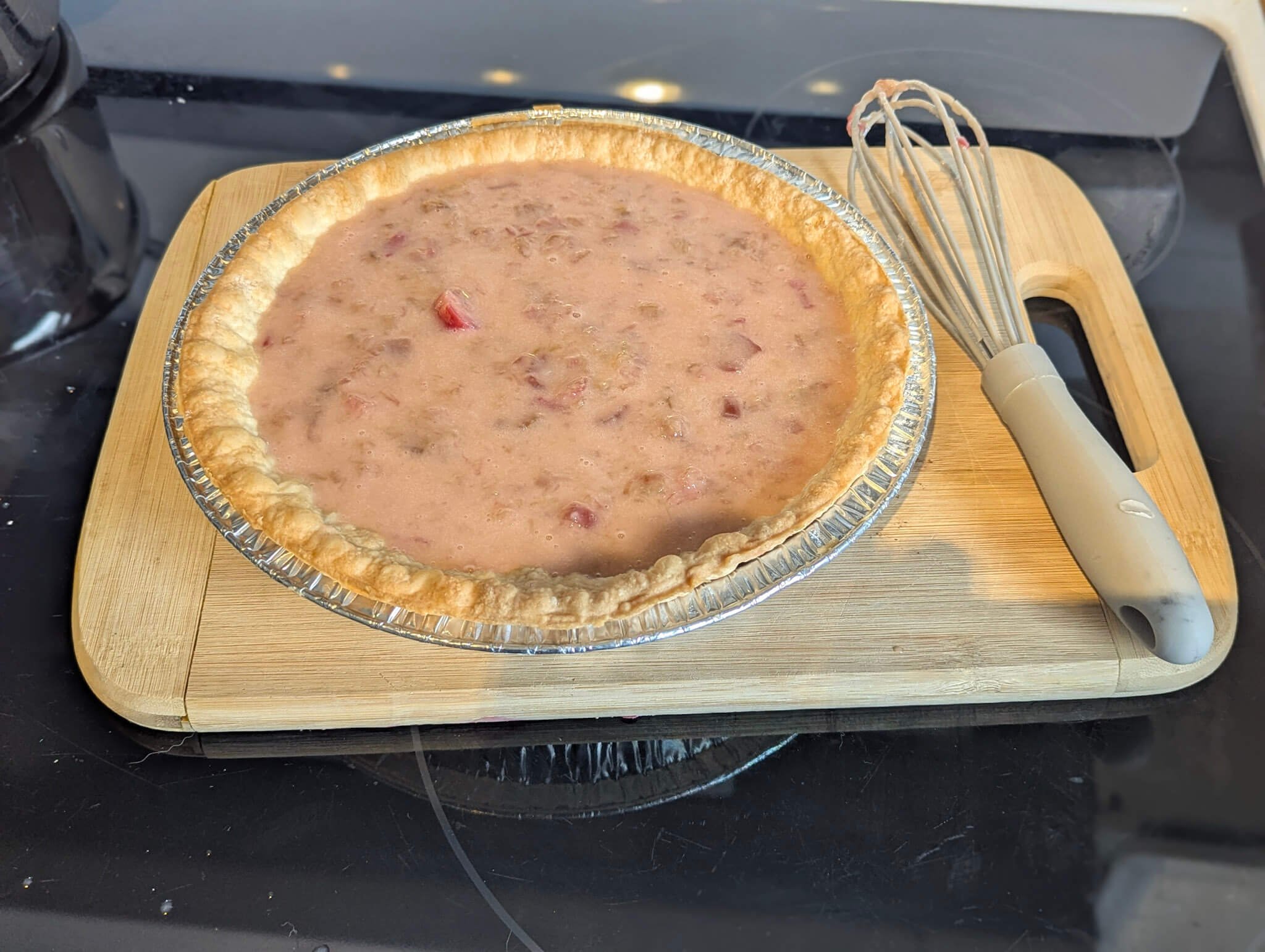 Rhubarb pie filling baked in a pie crust, ready for the meringue topping