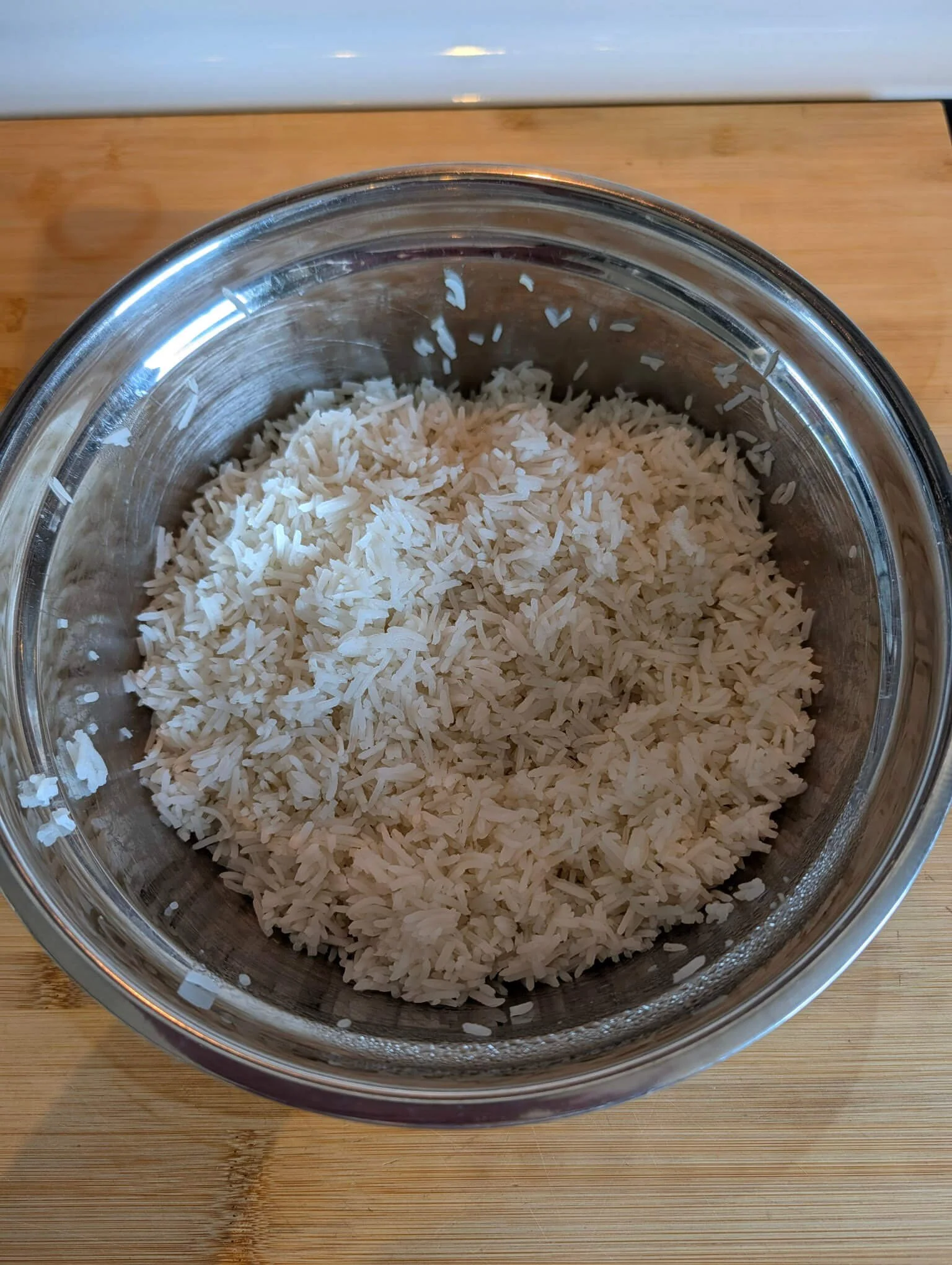 Cooked basmati rice in a bowl before mixing into curried rice salad