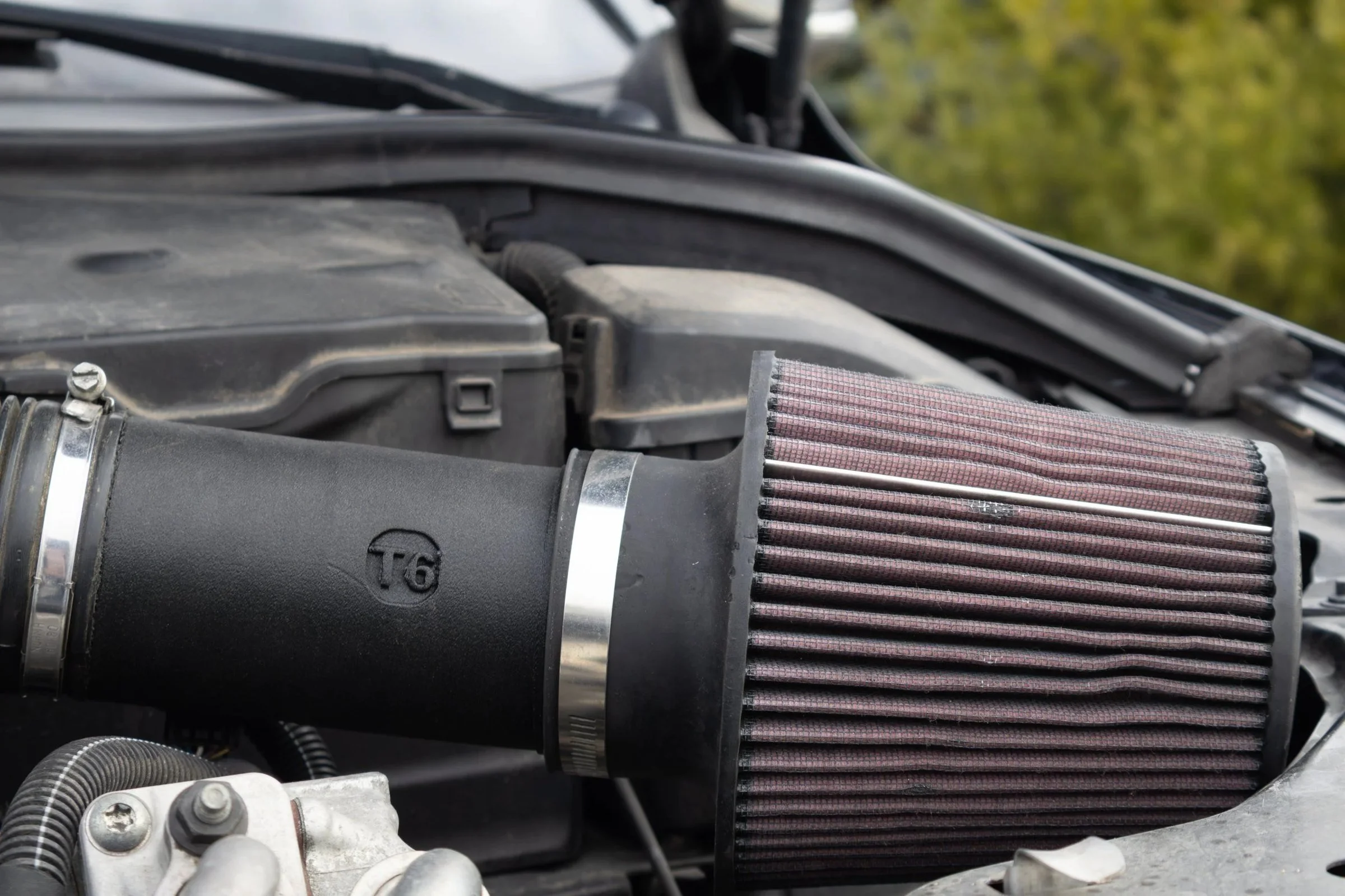 Close-up of the T6 logo on the SilvaDes printed intake (v4), cone filter attached