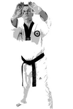 A person in a martial arts uniform performing a punch or block move with hands raised in front of them.