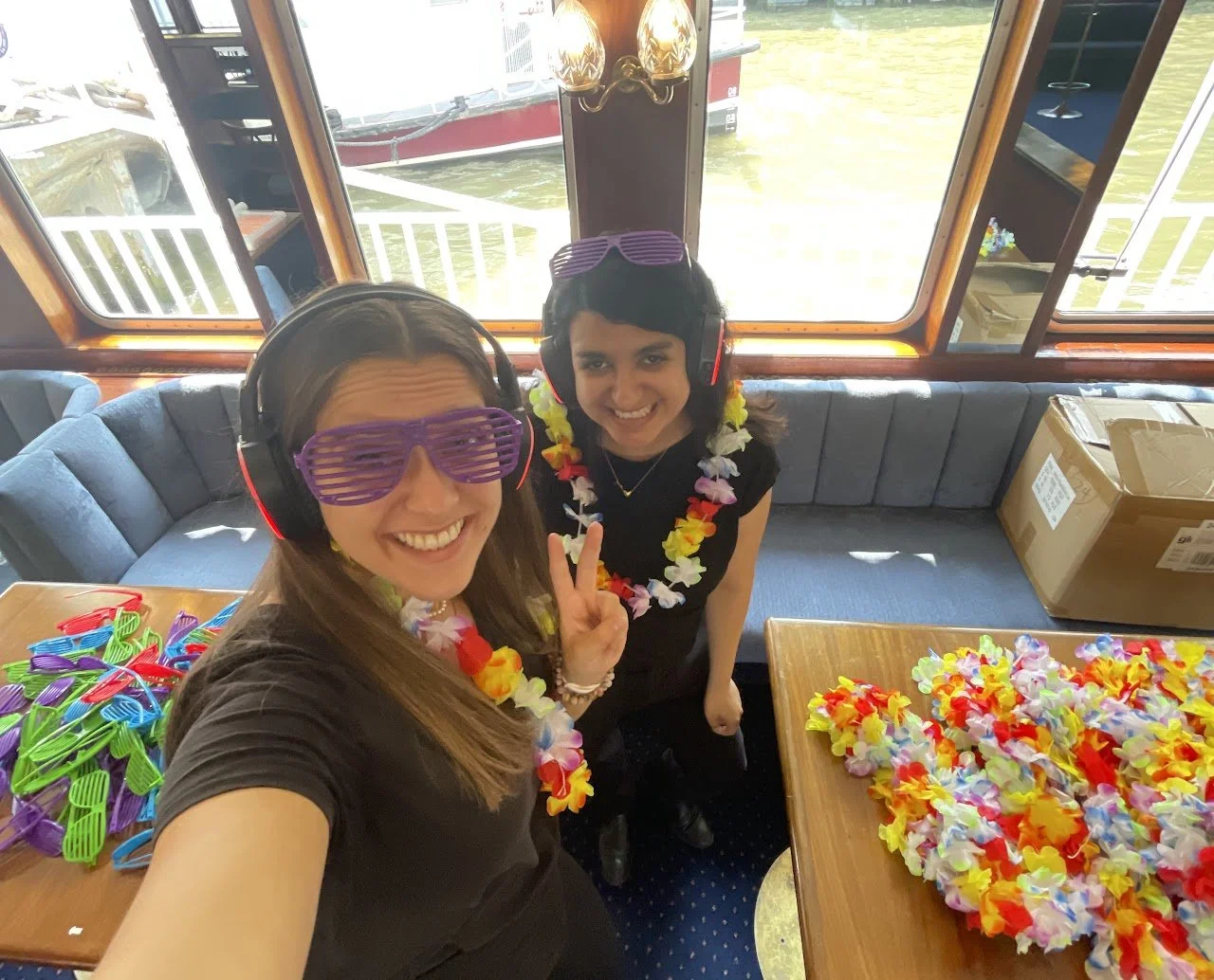 Event staff members enjoying a themed onboard event moment while supporting guest experience during a live activation.