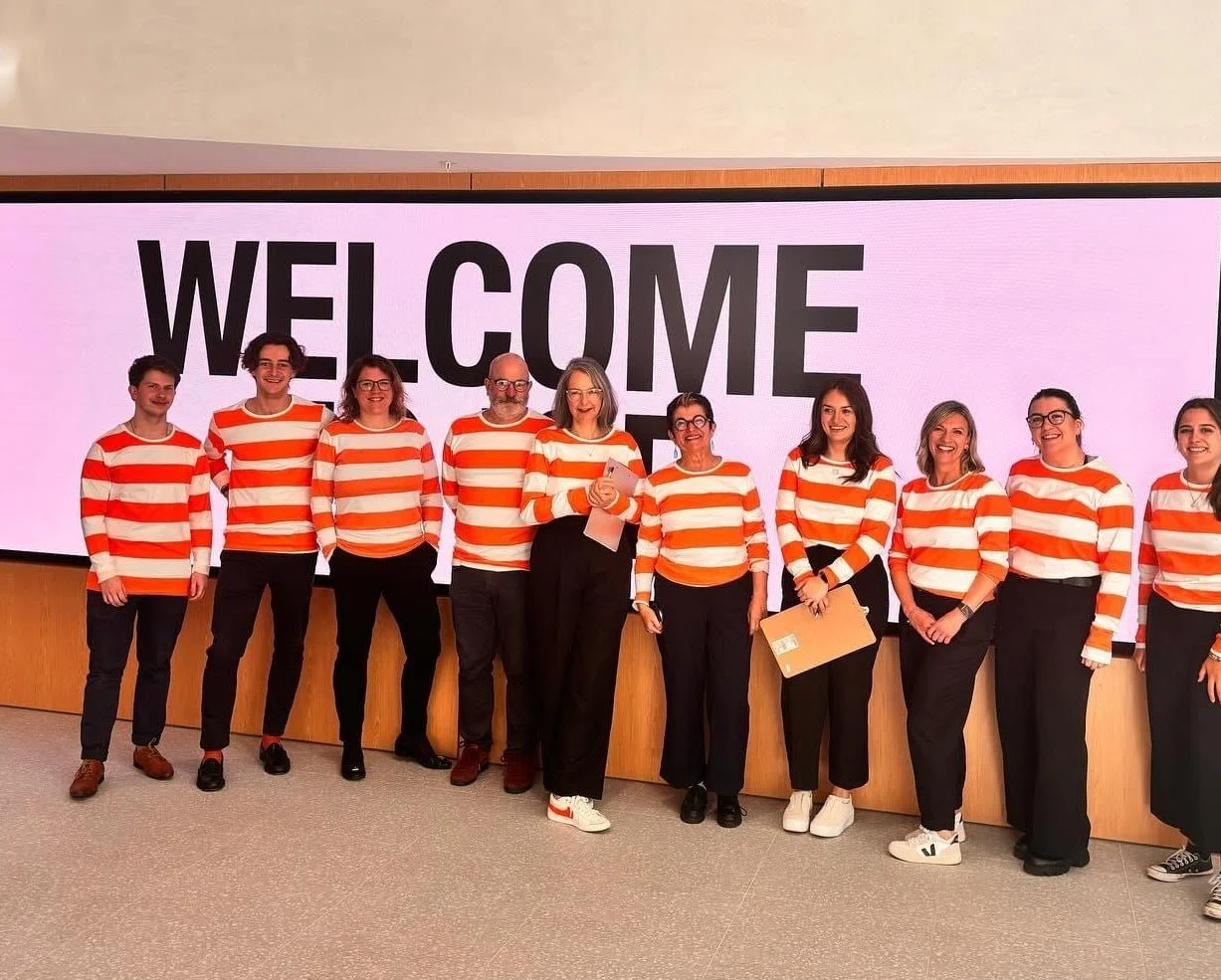Event team standing together on stage during a corporate welcome session, representing coordinated front-of-house operations.