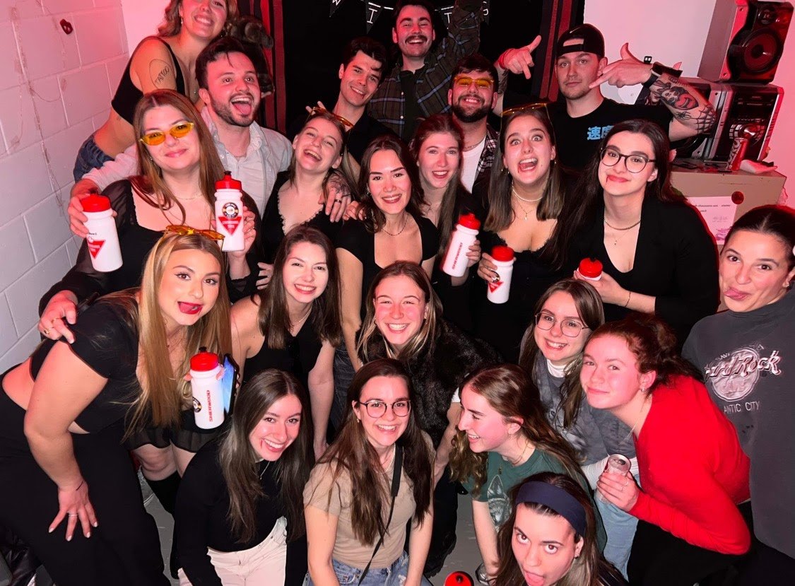 Event staff team celebrating together after a successful live event shift.