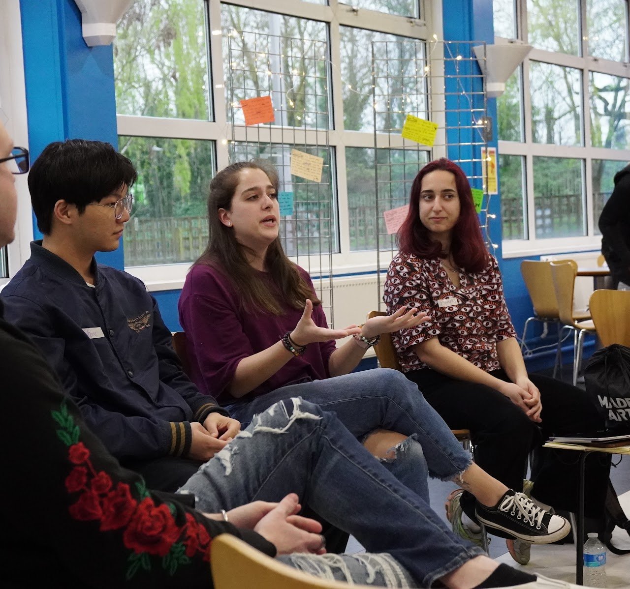 Participating in a dynamic group discussion, sharing ideas and actively contributing during an event management workshop.