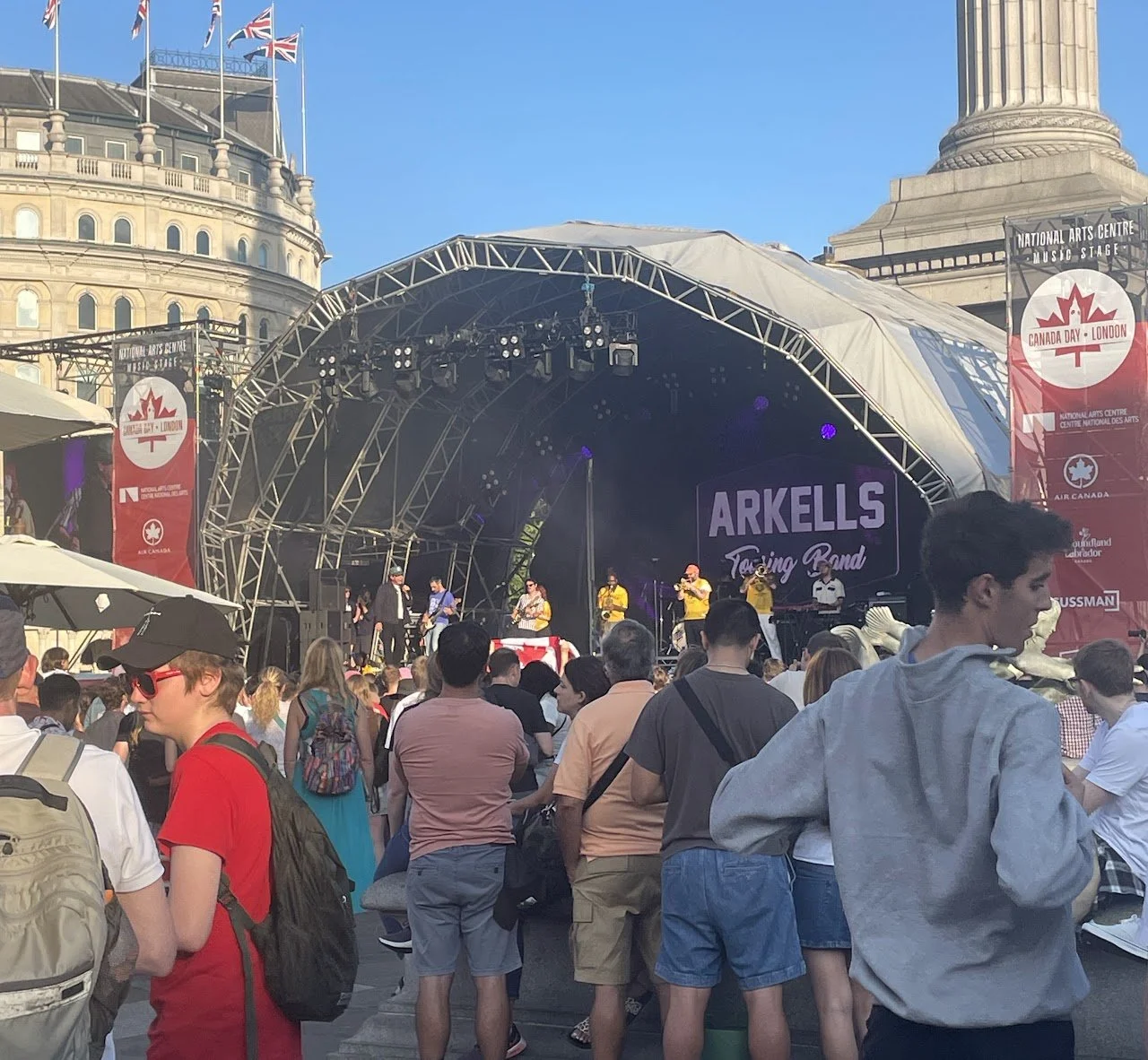 Audience gathered in front of the main stage during a live outdoor concert, capturing the scale of the event.