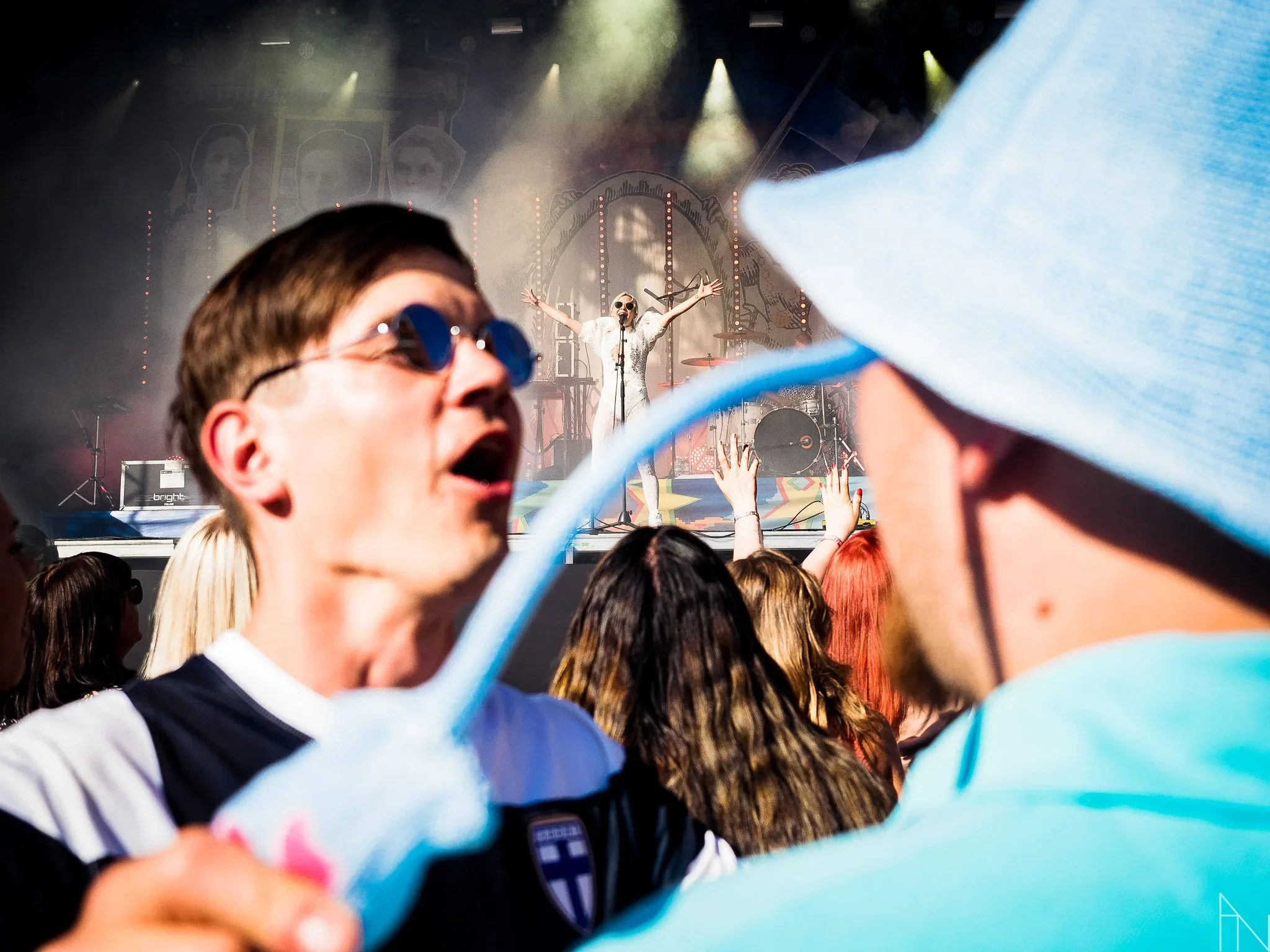 Musiikkitapahtuma, jossa yleisö nauttii keikasta, esiintyjä esiintyy lavalla taustoineen ja ihmiset tanssivat ja juhlivat.