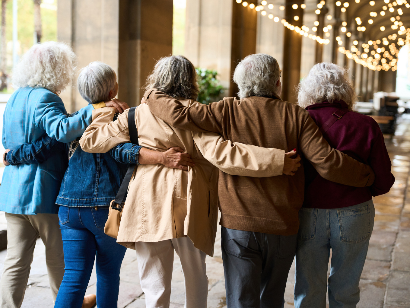 A group of women with their arms around each other.