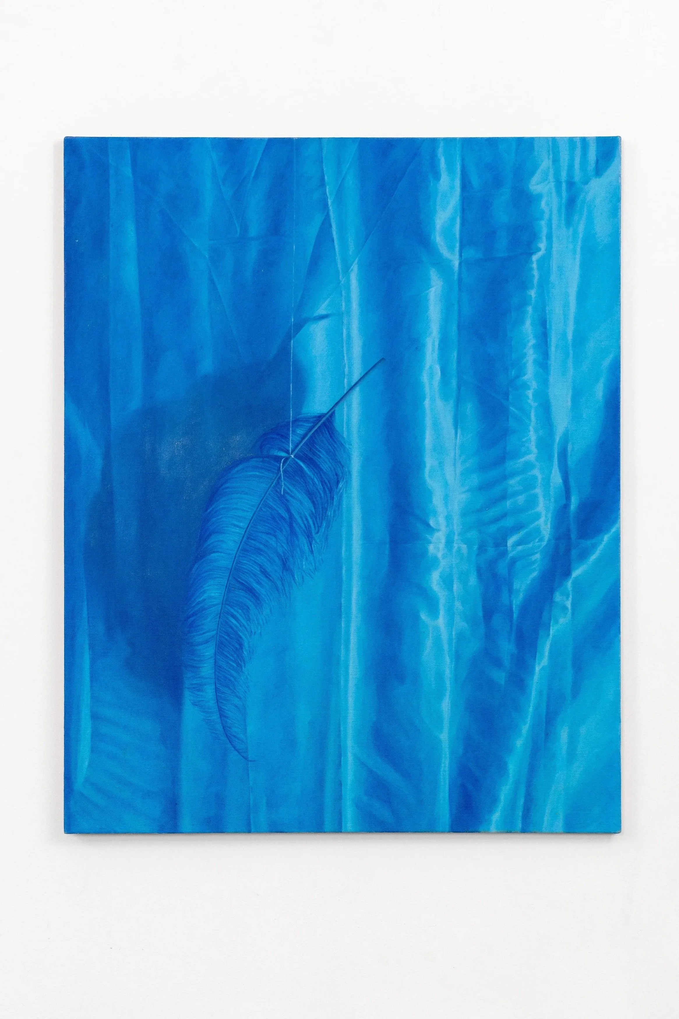 A blue painting depicting a large feather or leaf, with light streaks and textured details, mounted on a white wall.