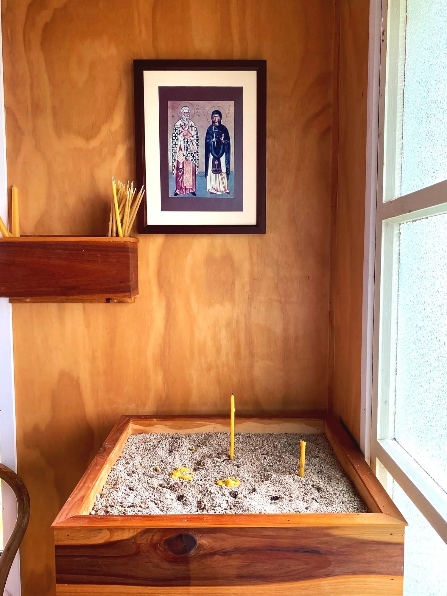 Candle stand and icon inside Sts Cyprian & Justina Orthodox Church in Auckland, New Zealand