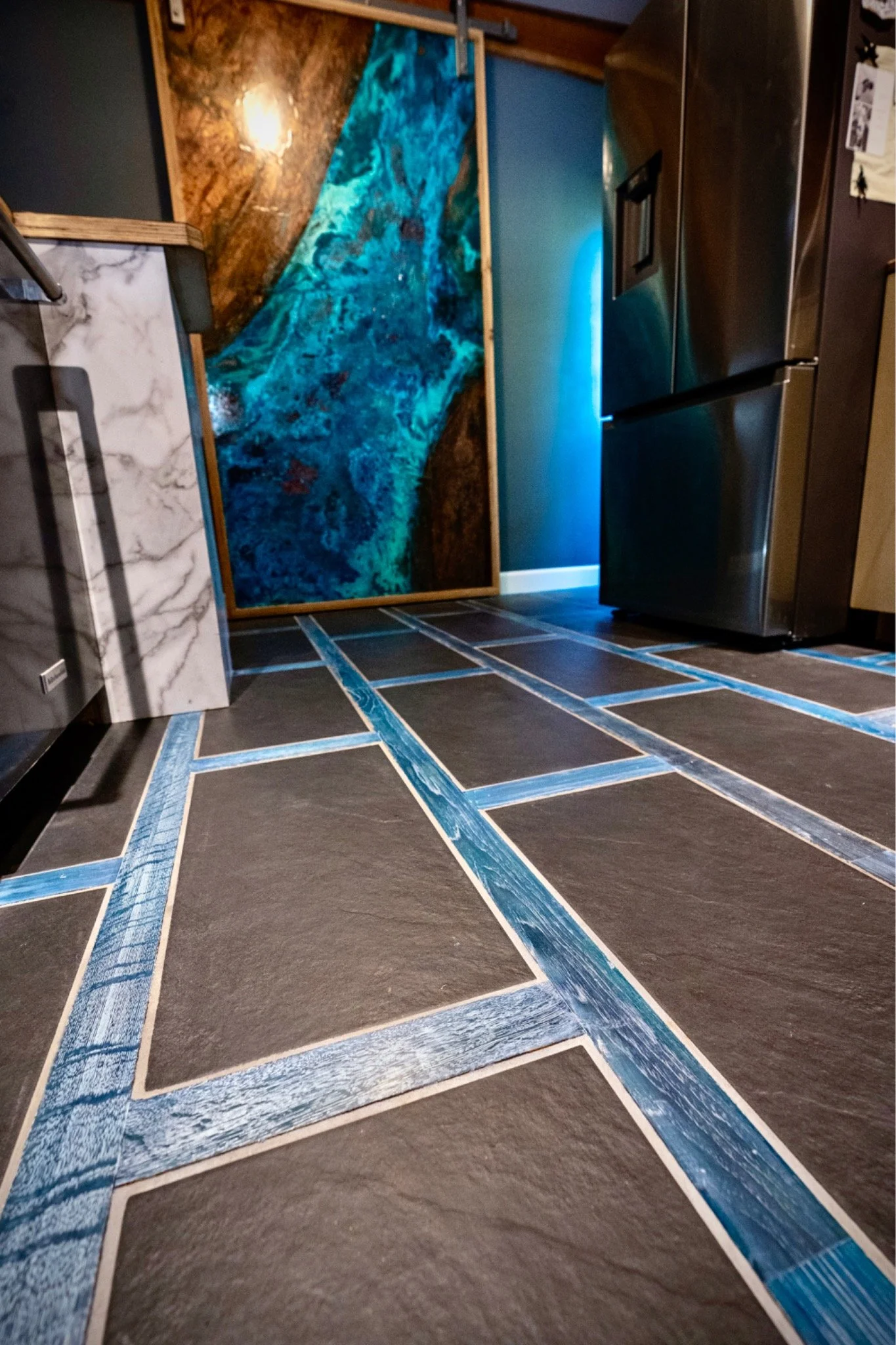 Custom mixed-media floor combining tile and hardwood in a geometric design in Fayetteville, West Virginia, by Goodman Custom Flooring.