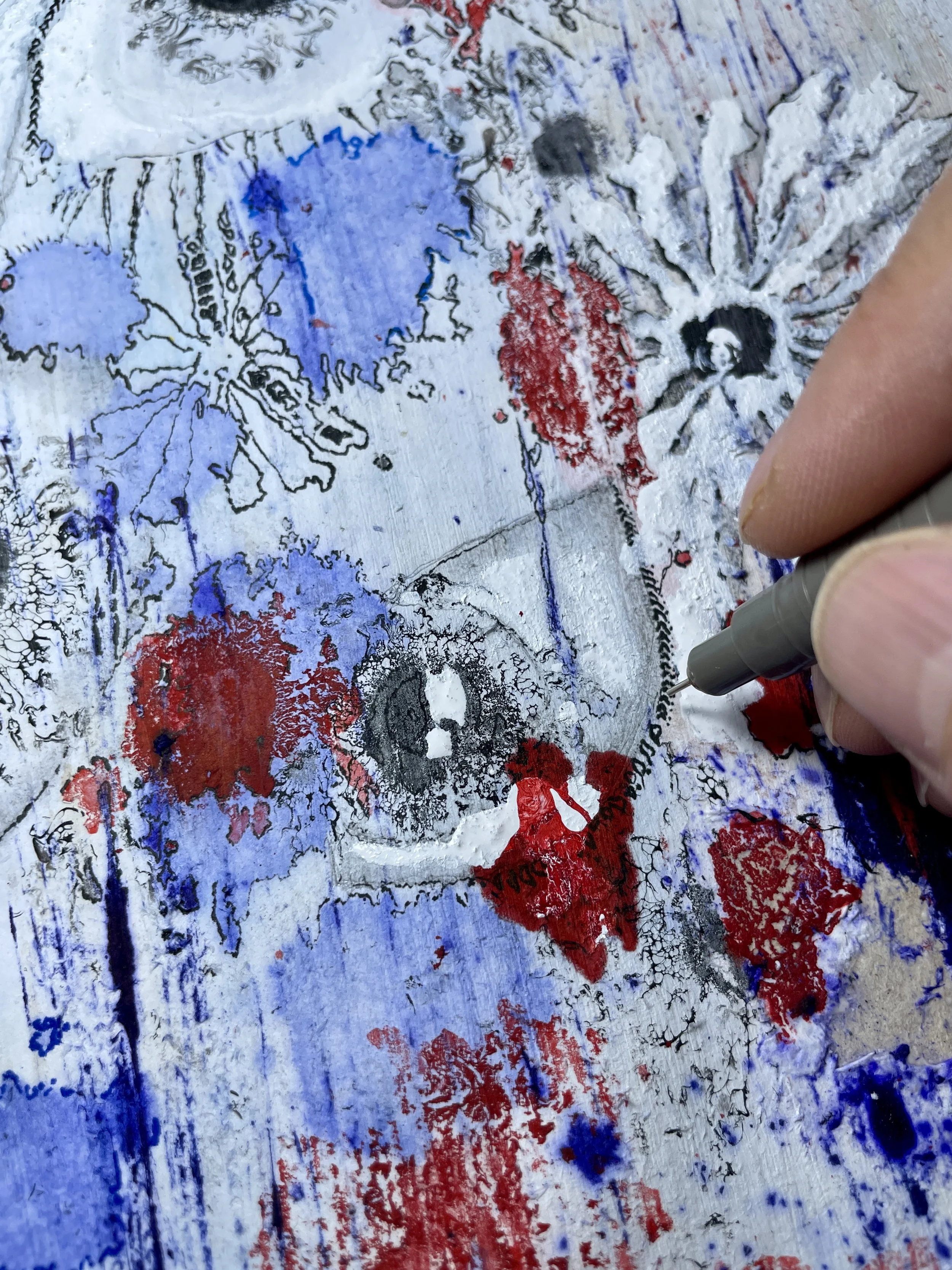 Close-up of a drawing intervention during the development of a material-based artwork.
