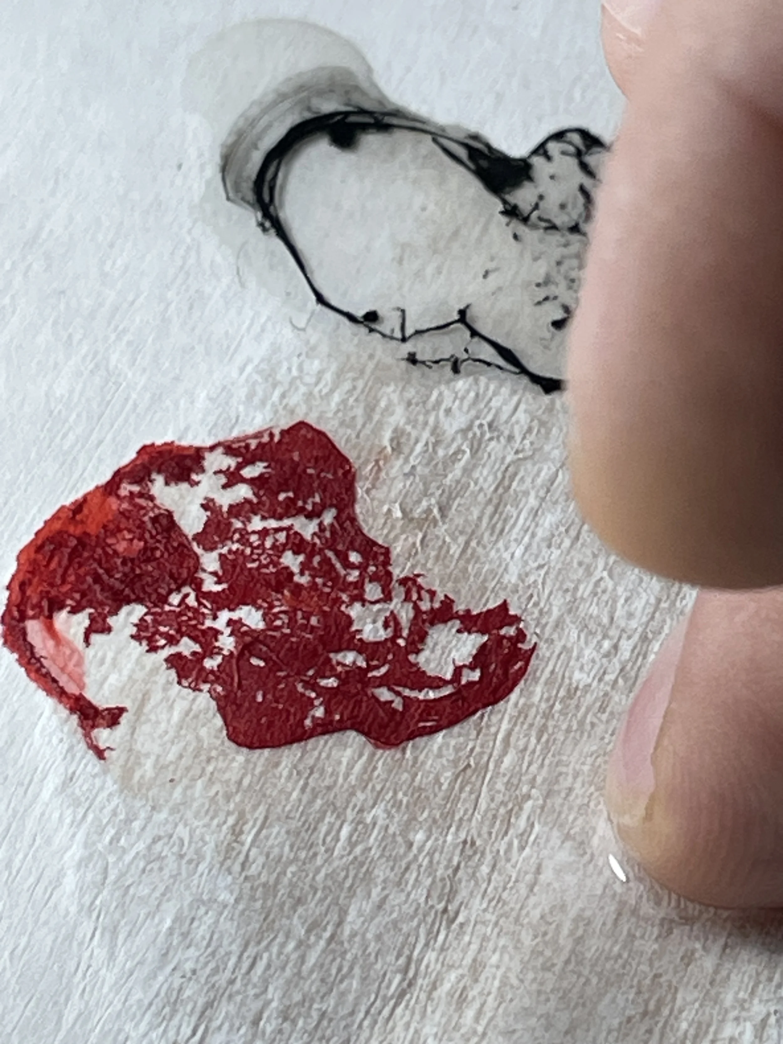 Close-up of material intervention during the development of a work.