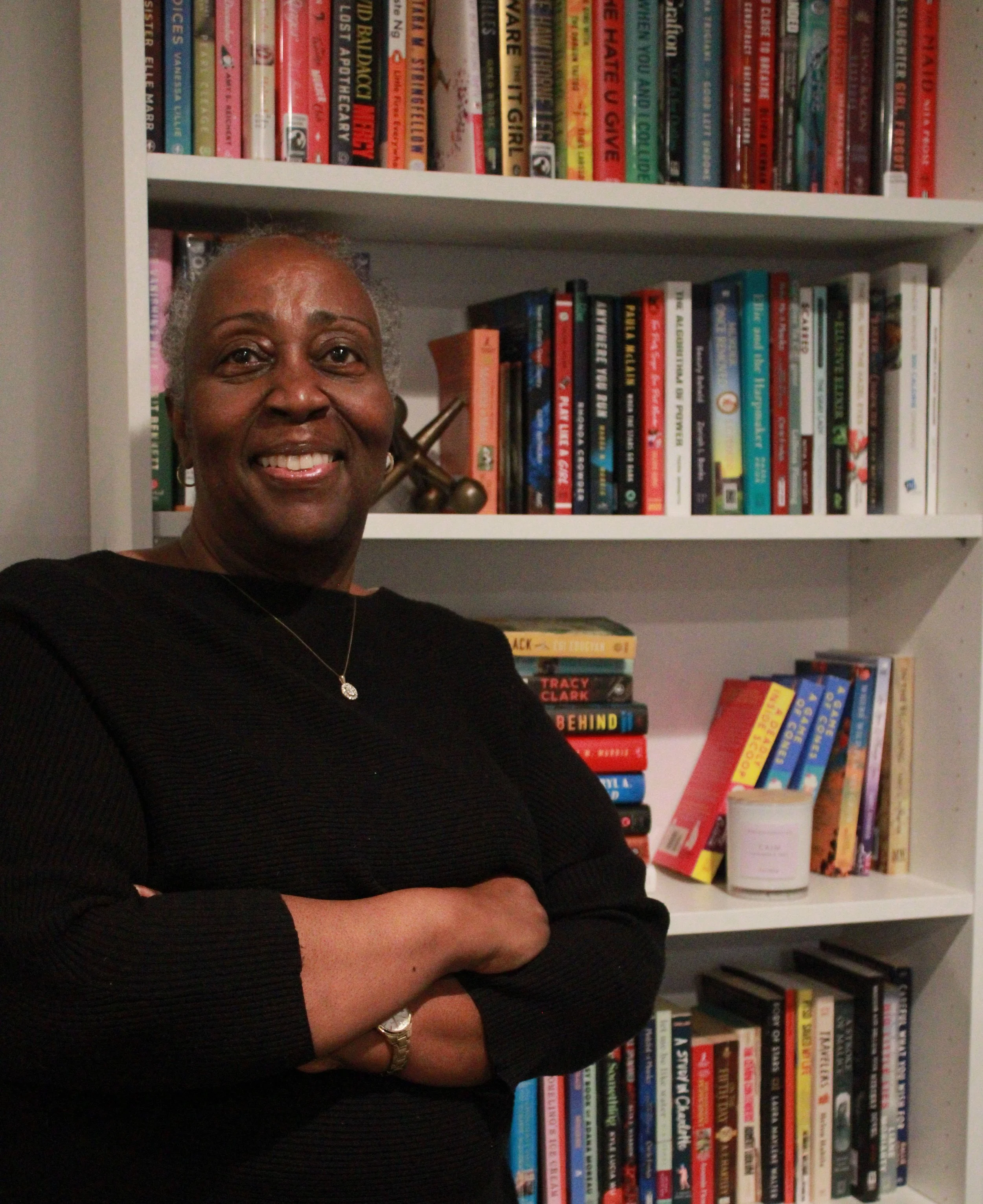 Coach Abby Standing in front of bookshelf