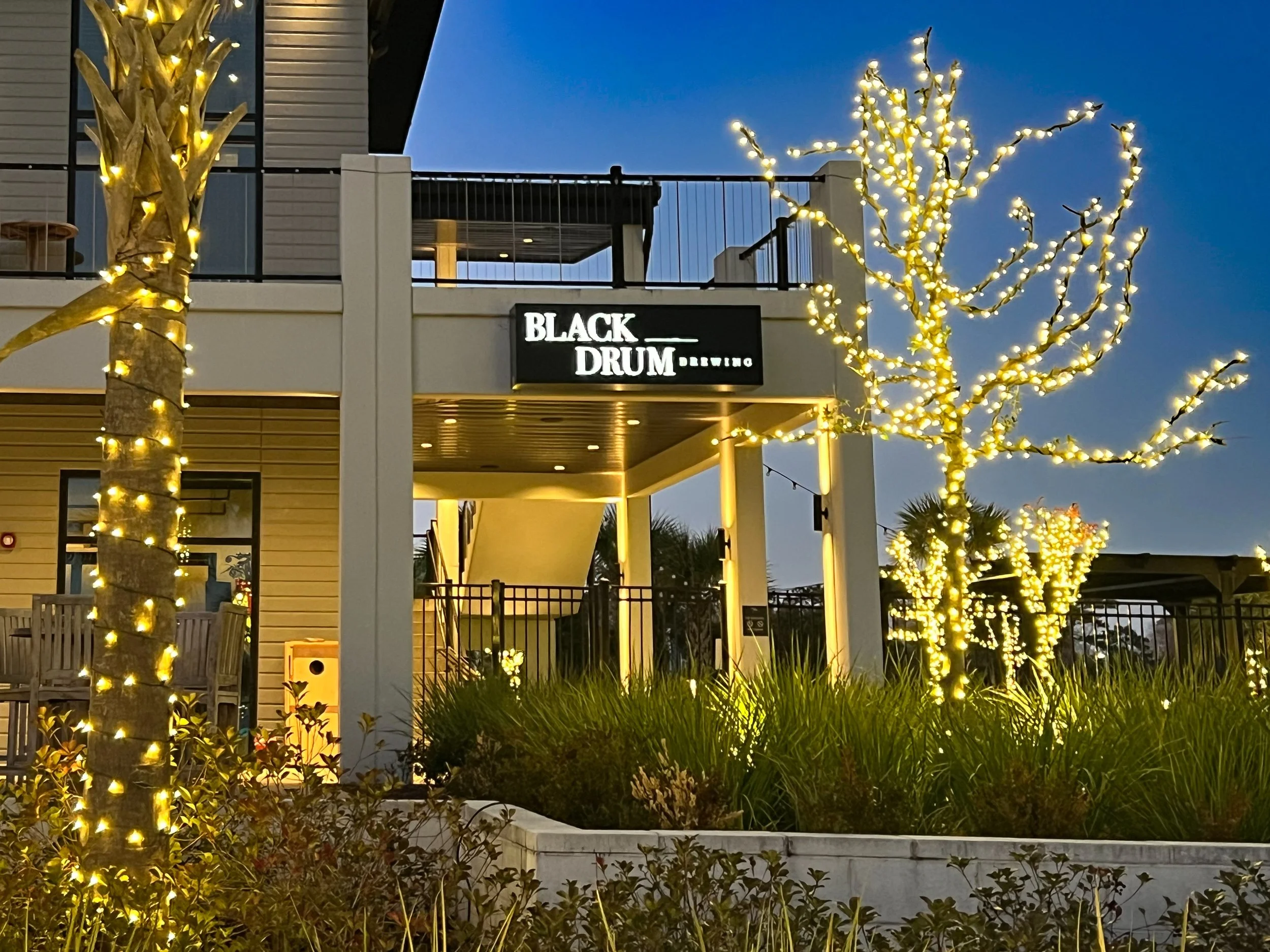 Black Drum Brewery entrance with warm evening lighting.