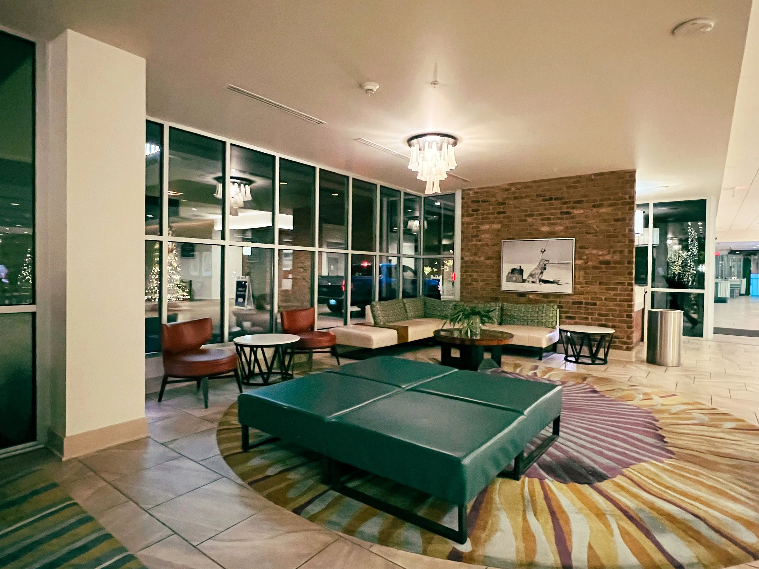 Hotel lobby with seating and a crystal chandelier.