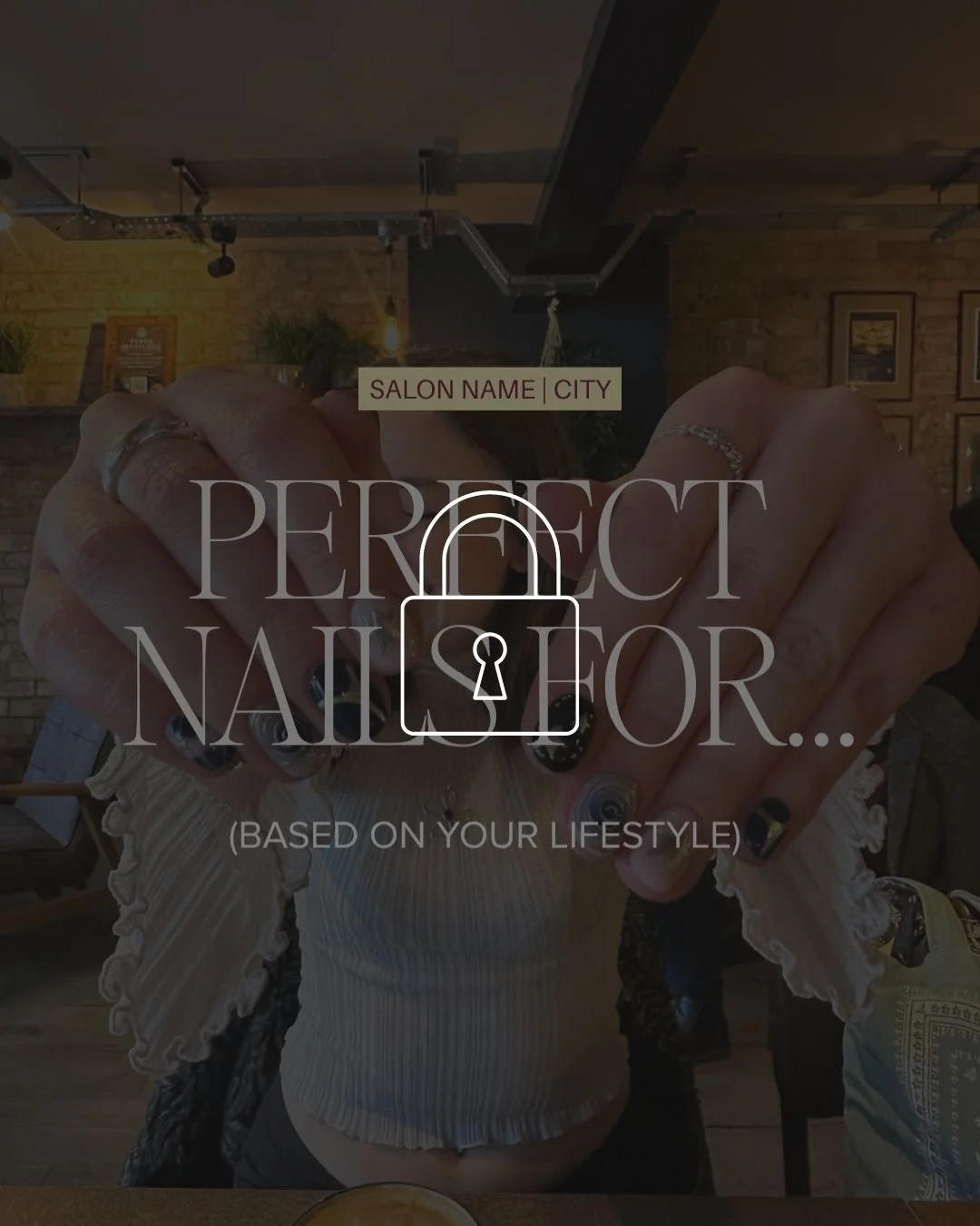 A person with painted nails showing a salon logo overlay, holding hands with fingers interlocked, inside a coffee shop or restaurant with a brick wall background.