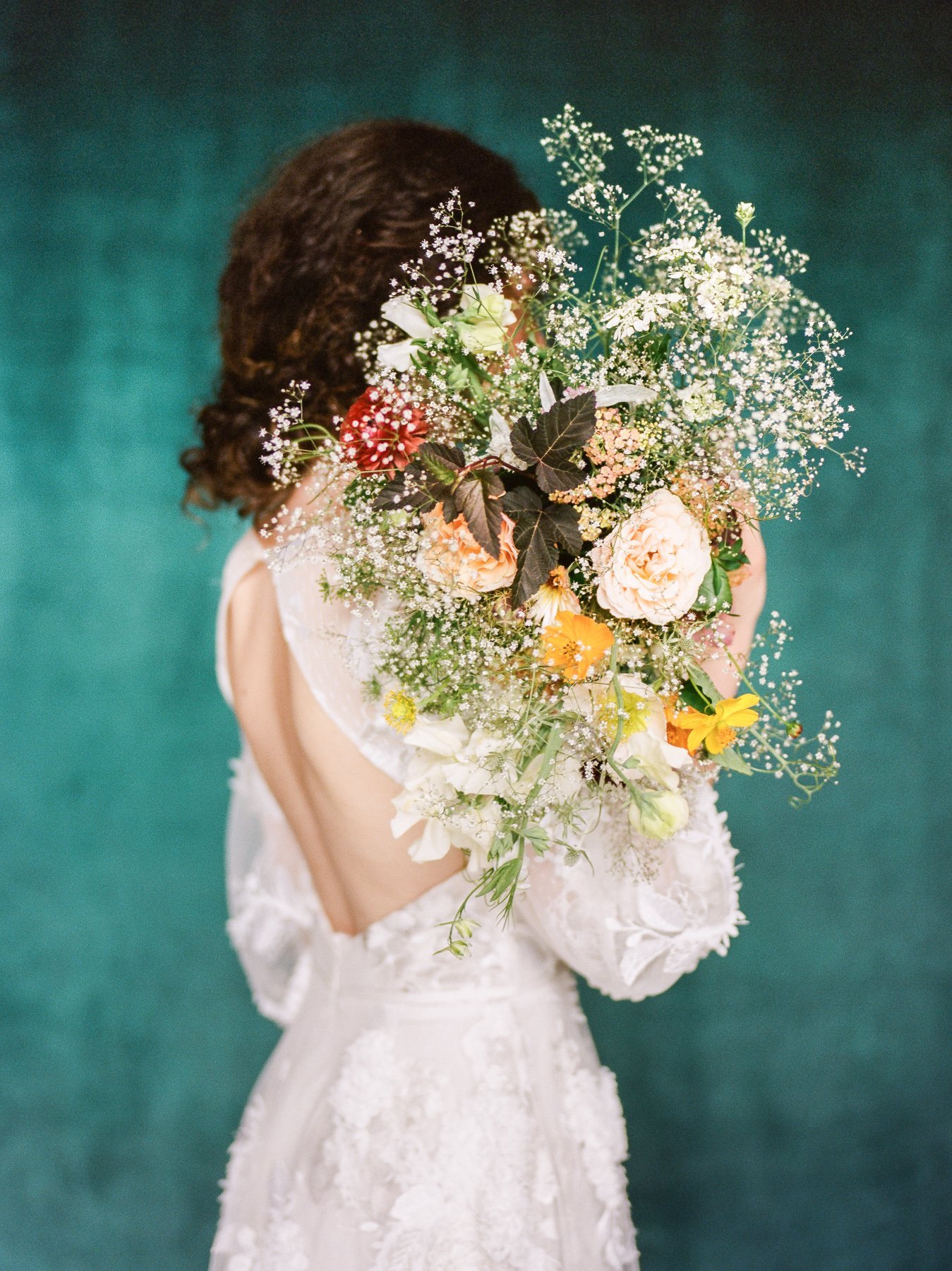 Baby's breath wedding bouquet and Marchesa wedding gown