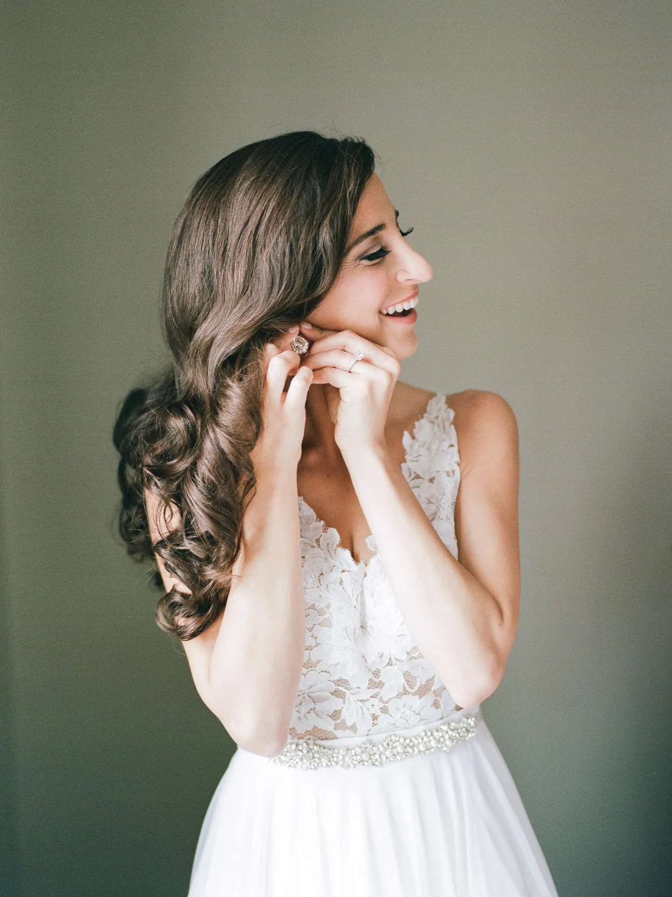 Bride Putting On Earrings