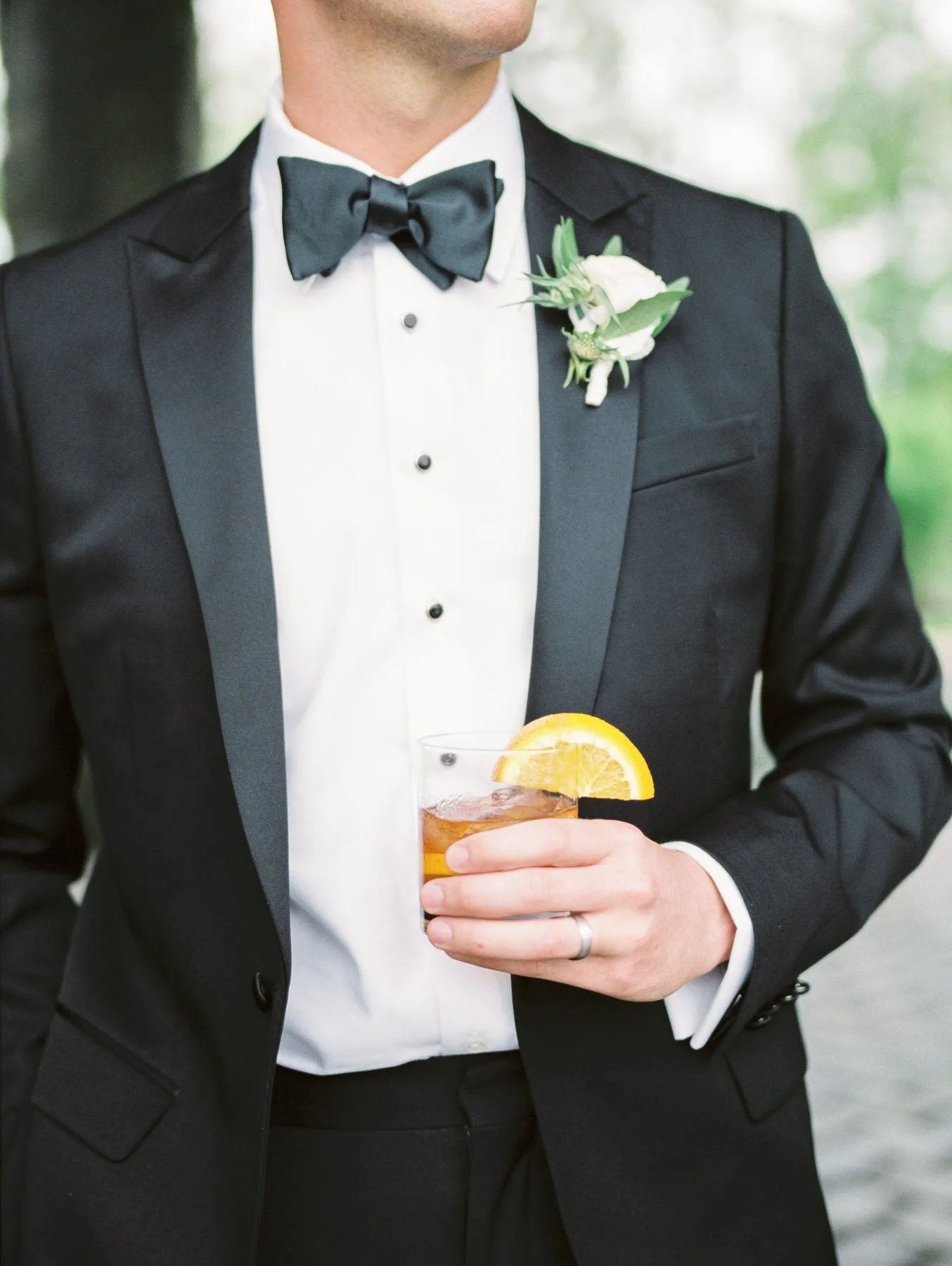 Groom holding specialty wedding day cocktail