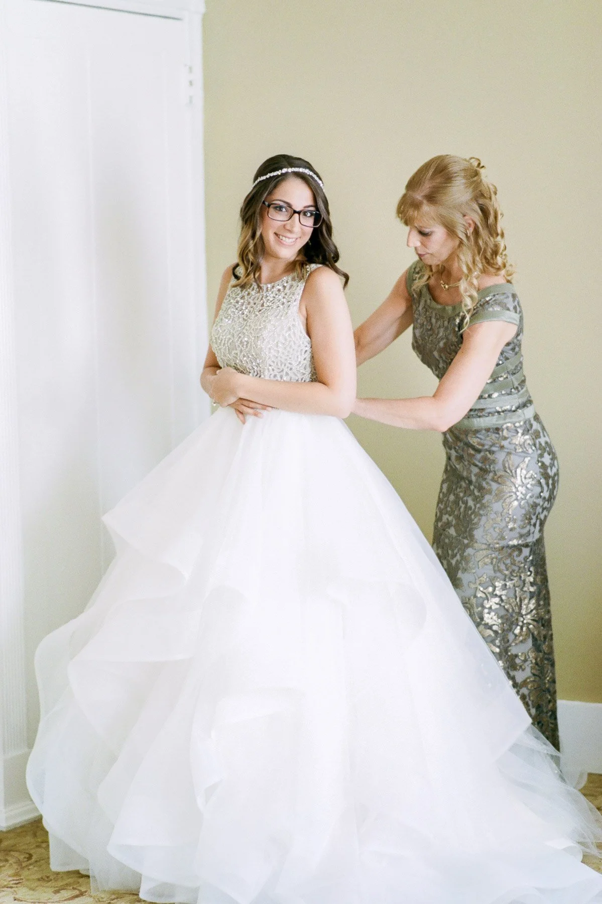 Bride getting ready in Hayley Paige wedding gown
