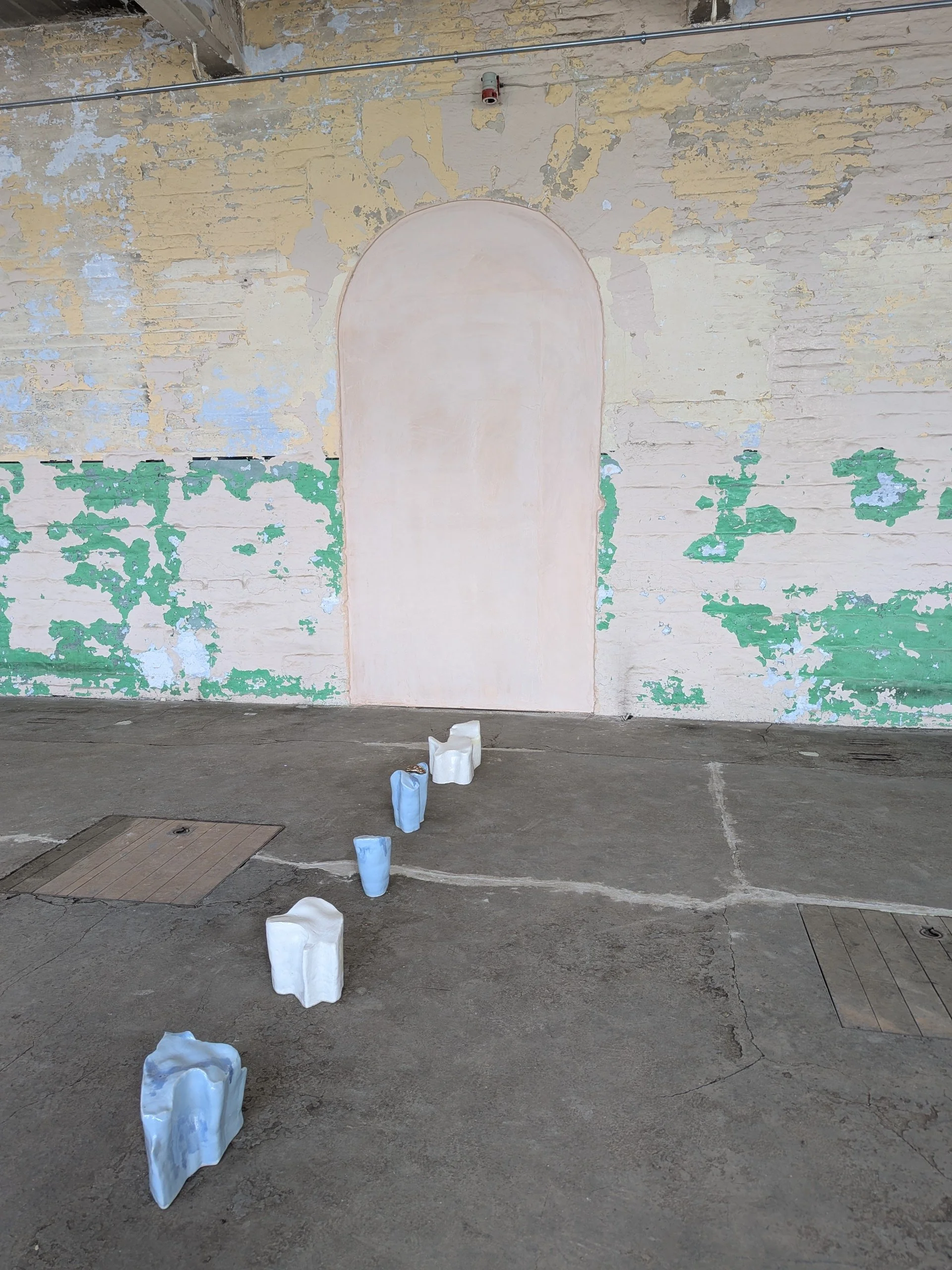 1. Cloth Islands (blue + white) installation 2026, ceramic, wax, bronze. 24 x 300 x 24cm.jpg