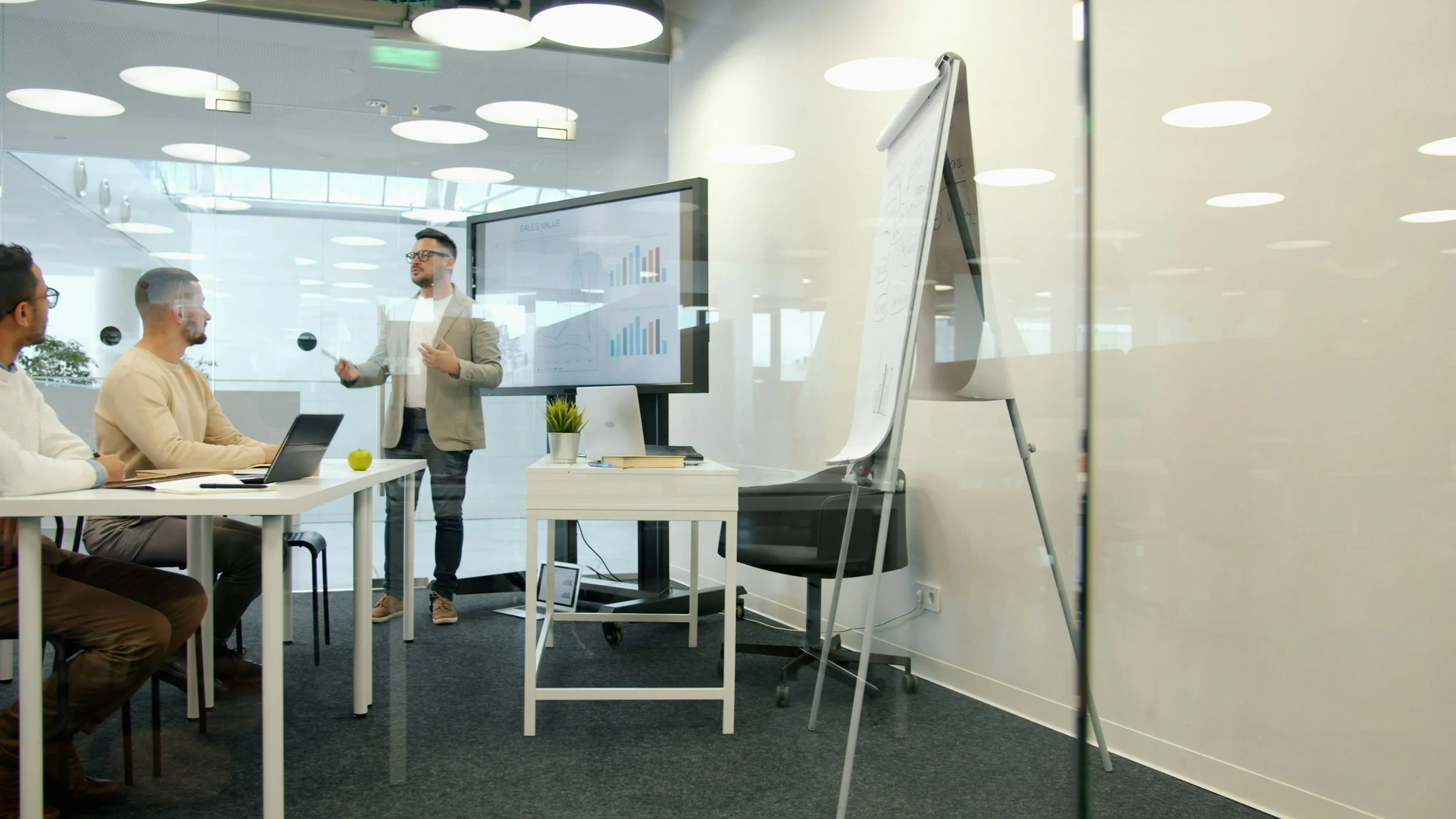 A manager discussing a planned rollout with colleagues in an office meeting