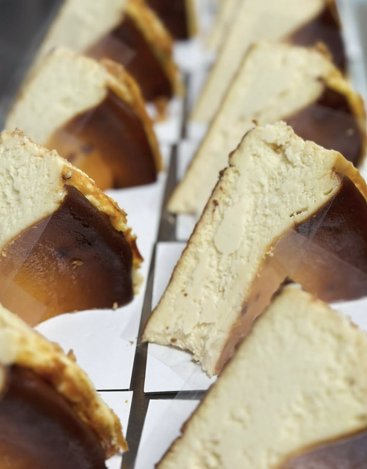 Close-up of sliced layered dessert with white cake, caramel, and chocolate layers.