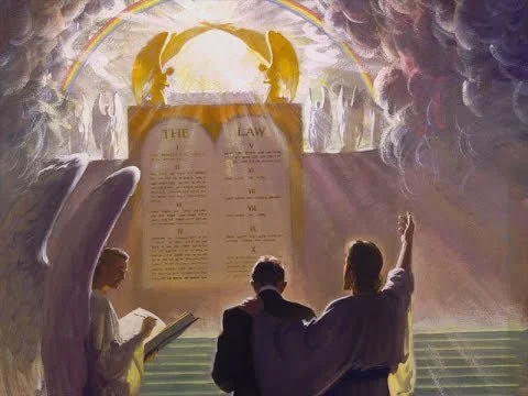 Three people, including a priest, gathered around a large open book or tablet in a church or religious setting, with a backdrop featuring a rainbow and angels, and a glowing display of the Ten Commandments.