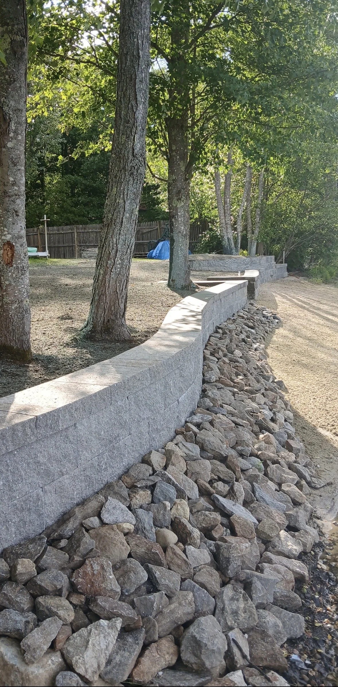 A curved stone beachfront retaining wall 