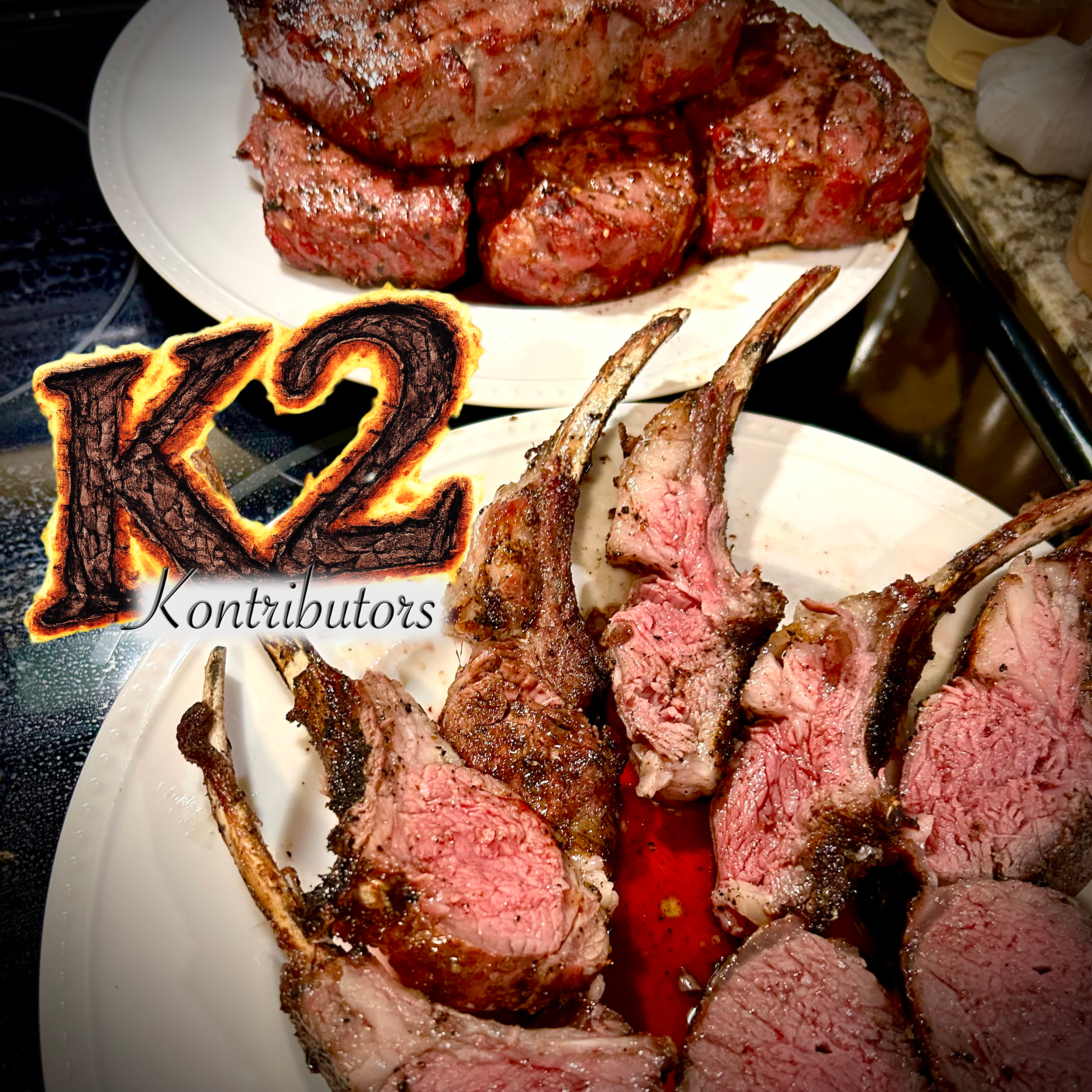 A plate of cooked lamb chops, some sliced to show pink interior, with charred edges, on a white dish. There is a grilled vegetable slice in the corner and some seasonings and condiments in the background.