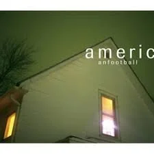 Part of a house with a window and a tree in front, against a dark green sky, with the words 'America football' partially visible.