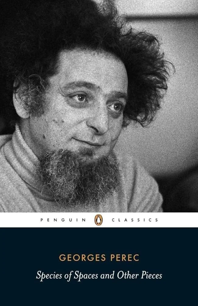 Book cover with black and white photo of Georges Perec with curly hair and a beard, titled 'Species of Spaces and Other Pieces' by Georges Perec, published by Penguin Classics.