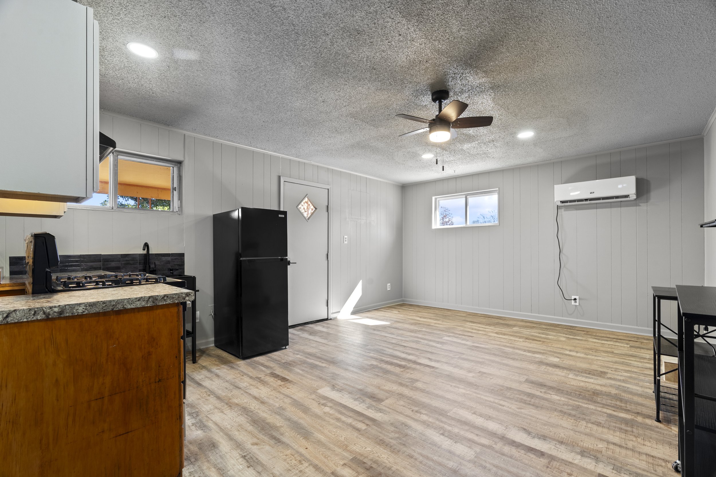 Entry, open plan living room and kitchen, new mini split hvac, ceiling fan