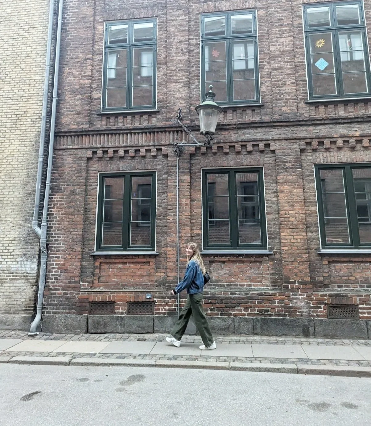 Caitlin Wick, licensed therapist in Providence RI, smiling warmly and walking