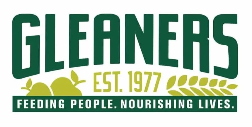 Logo for Gleaners featuring the text "Gleaners Est. 1977" and a slogan "Feeding People. Nourishing Lives." with an image of lemons and leaves.