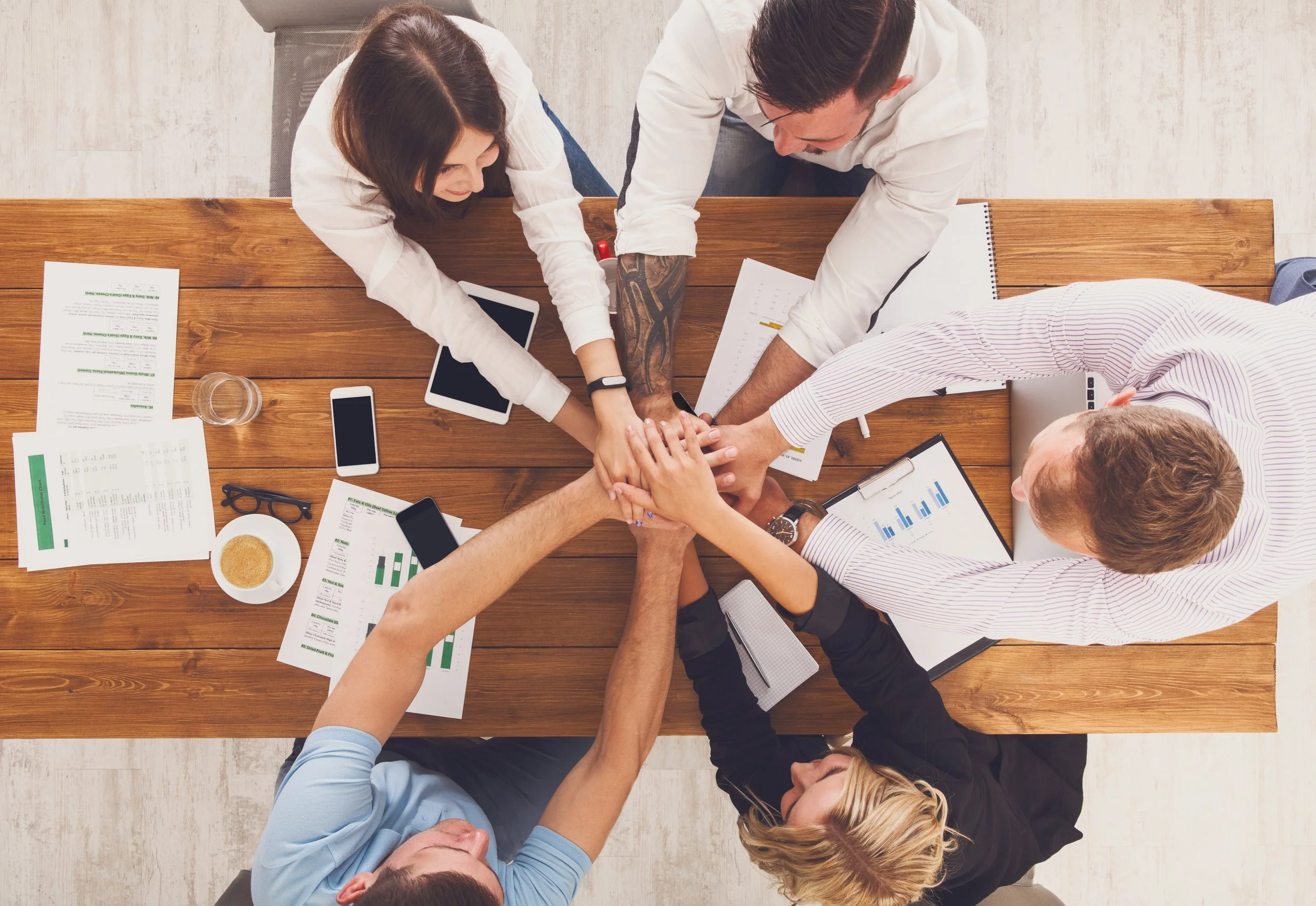 Language professionals collaborating as a team around a meeting table.