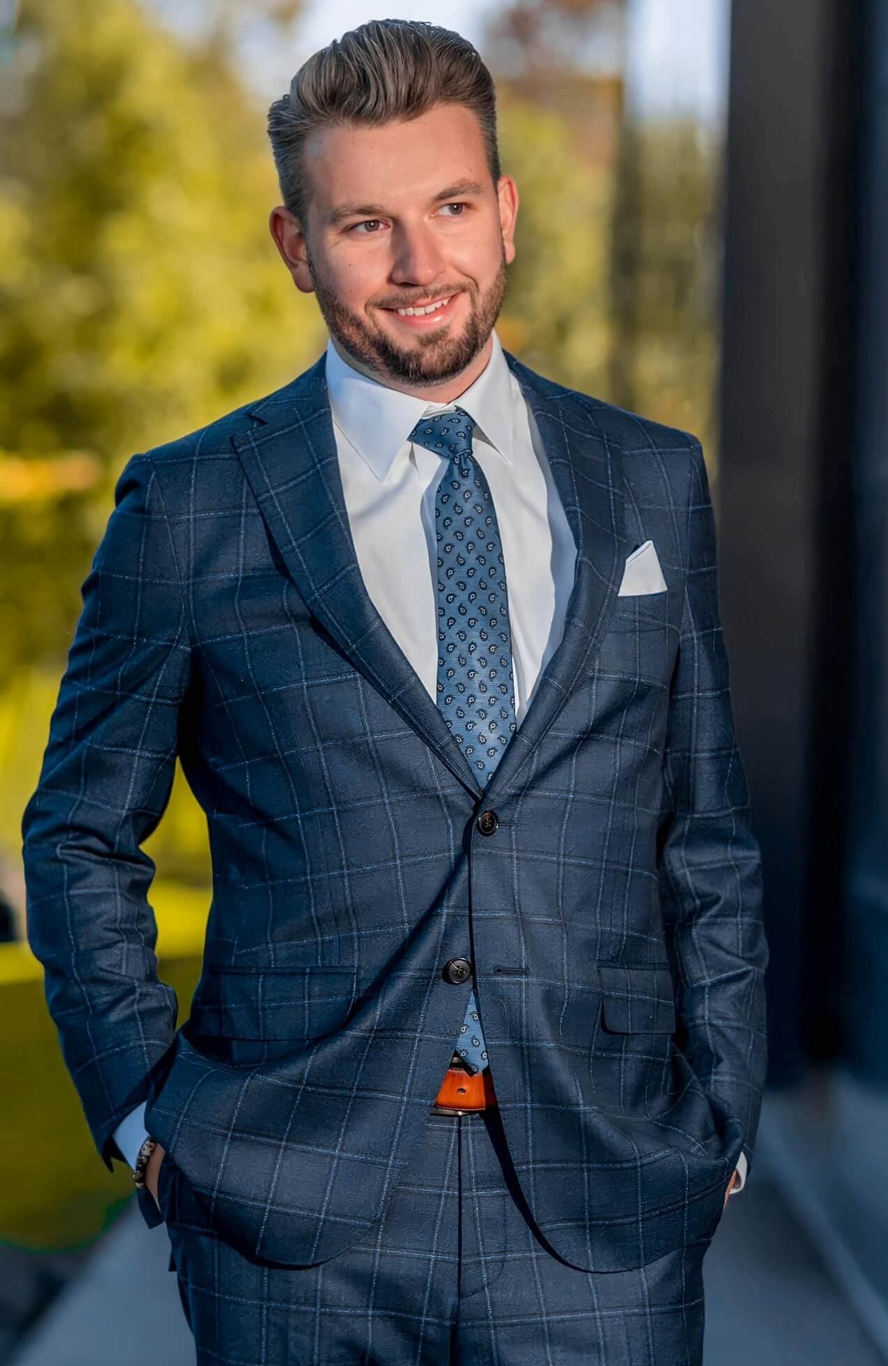 Professional healthcare executive CEO Brandon Robertson headshot of businessman in blue suit with natural light background, modern corporate photography by Krizia Studios Minneapolis