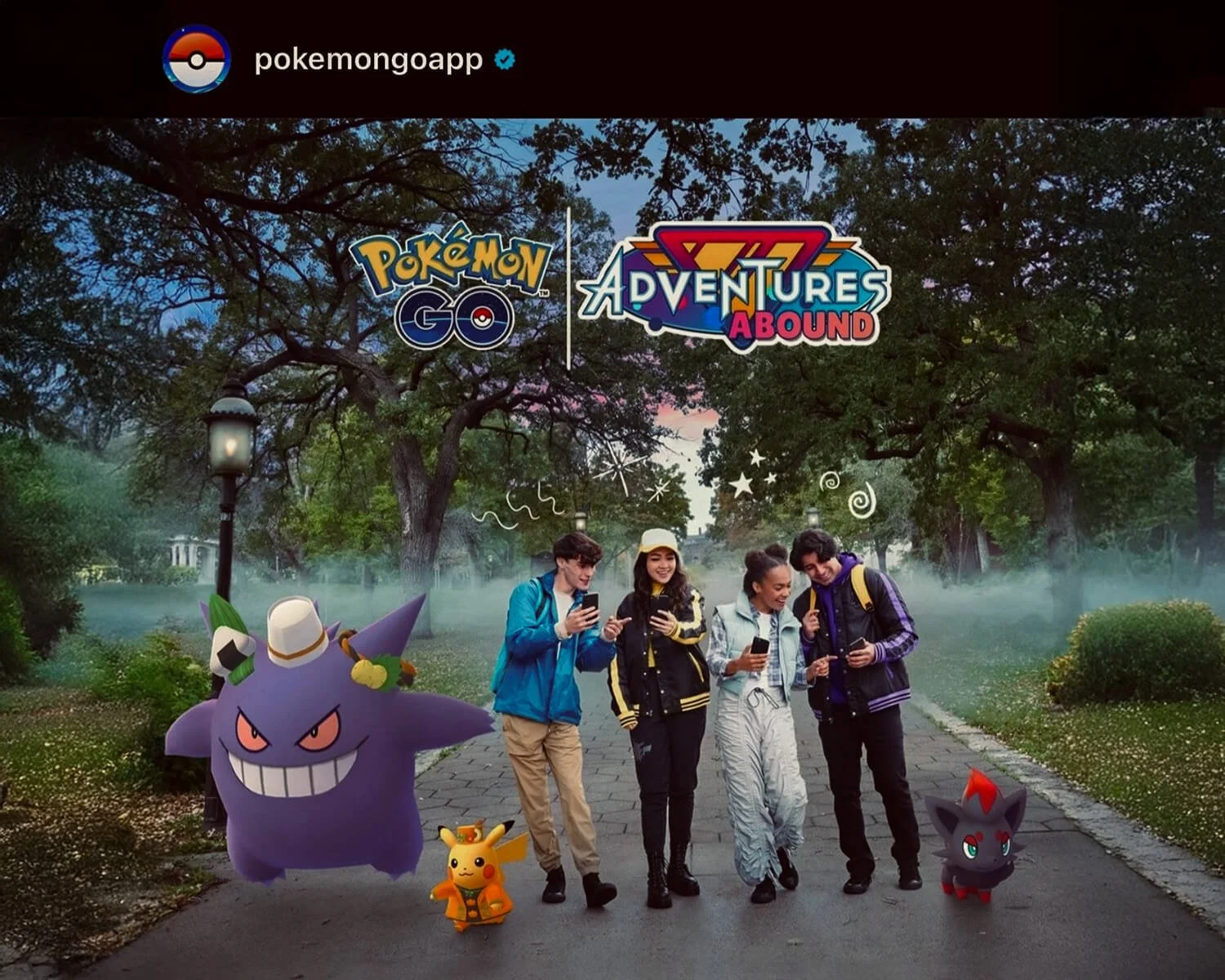 Four people standing on a park pathway, all looking at their phones and smiling, with animated Pokémon characters Gengar, Pikachu, and dark-type Pokémon at their sides, and the logos for Pokémon GO and Pokémon Adventures Abroad overhead.