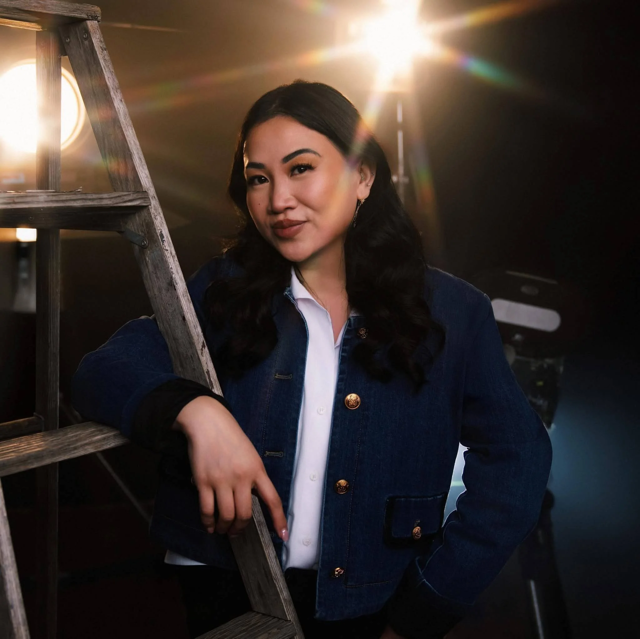 Krizia Gaile, founder of Krizia Studios, standing in her downtown Minneapolis commercial photography studio surrounded by professional lighting equipment