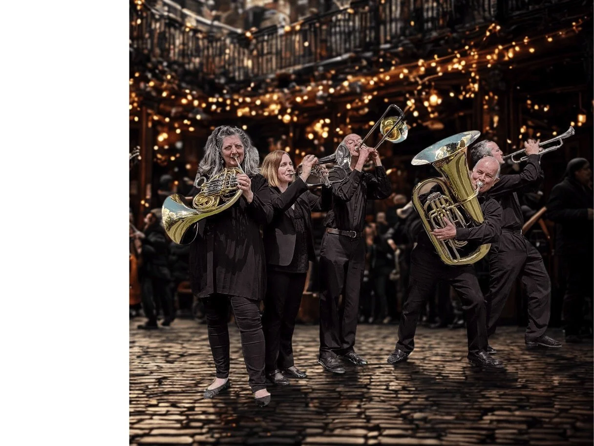 A group of musicians performing with brass instruments on a stage decorated with string lights.