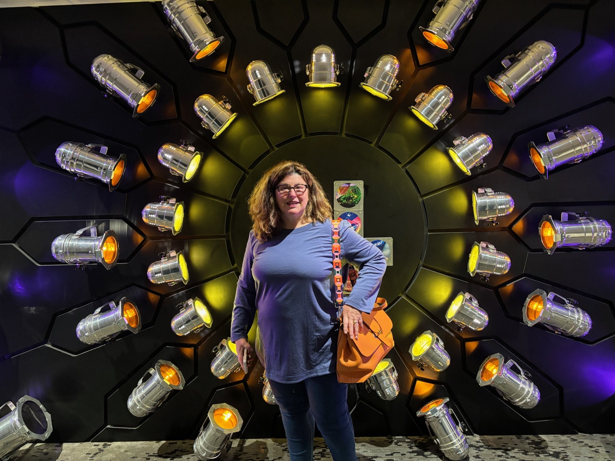 Caroline Langer author of Emerald Eyes in front of an art installation of spotlights at the Hotel Rock Lititz