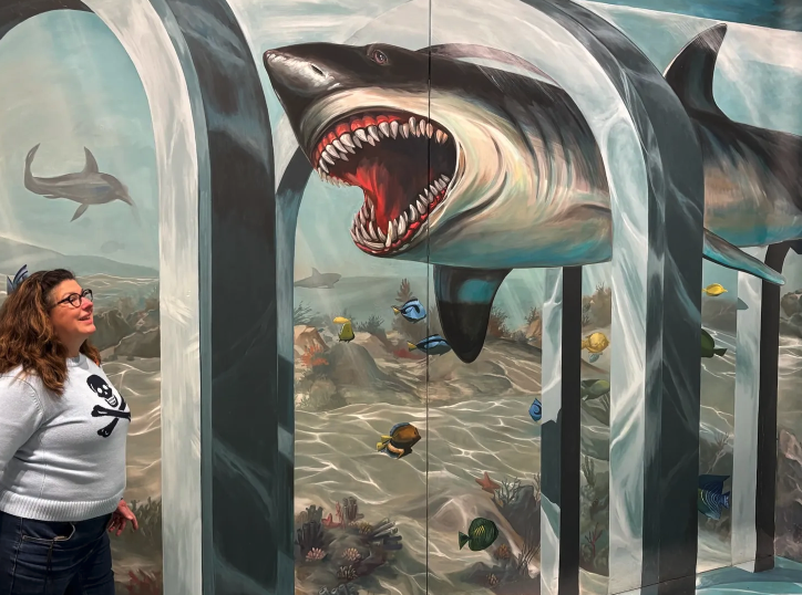 Image from Interactive Museum showing two sharks face to face, one a great white and one Caroline Langer, Author of Emerald Eyes