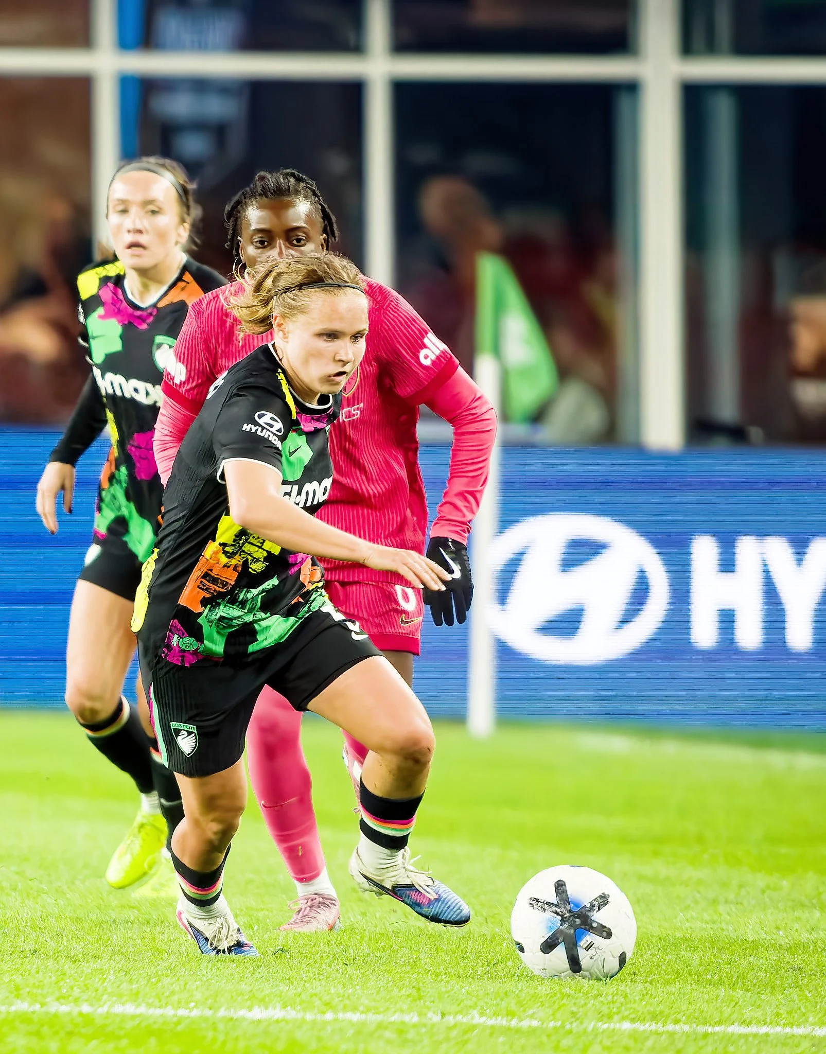 Three soccer players in action 