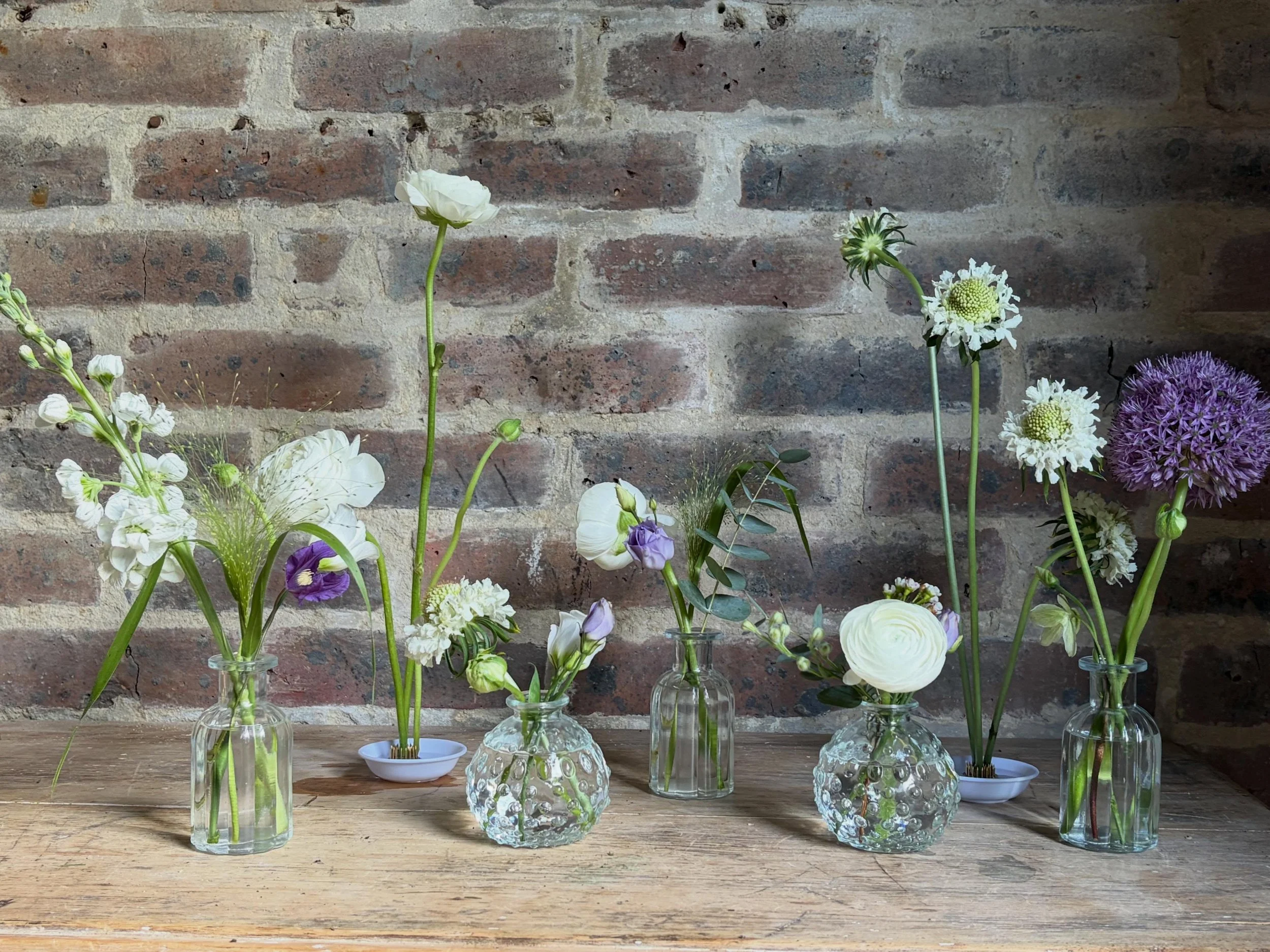Bud vases and ikebana bowls may be small but they can make a big impact if used right.

Perfect for banquet tables, intimate weddings or couples looking for a more relaxed style, they add beautiful pops of colour and height whilst letting your guests