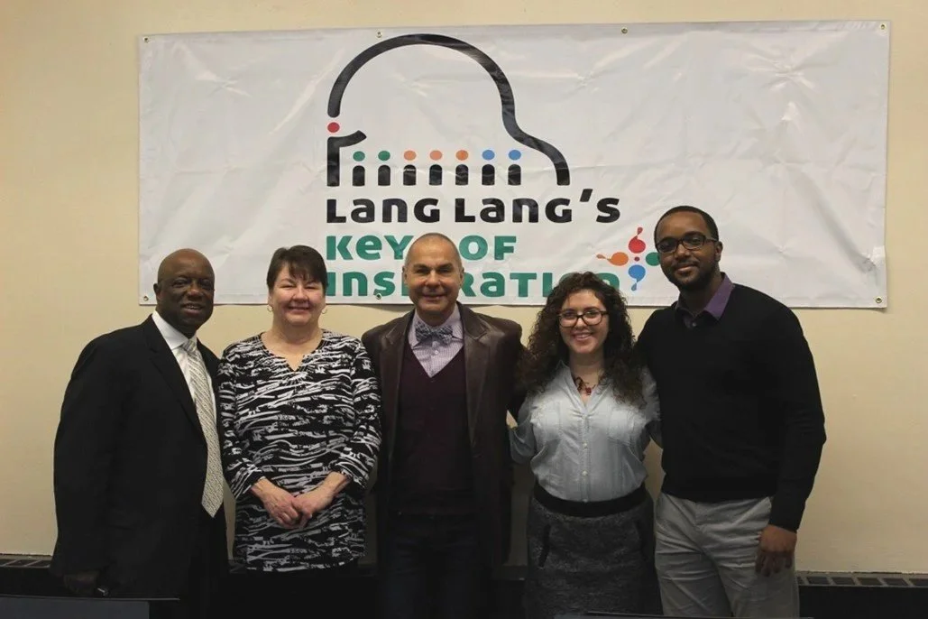 Group of five diverse people standing in front of a banner that reads "Lang Lang's Key of Inspiration"