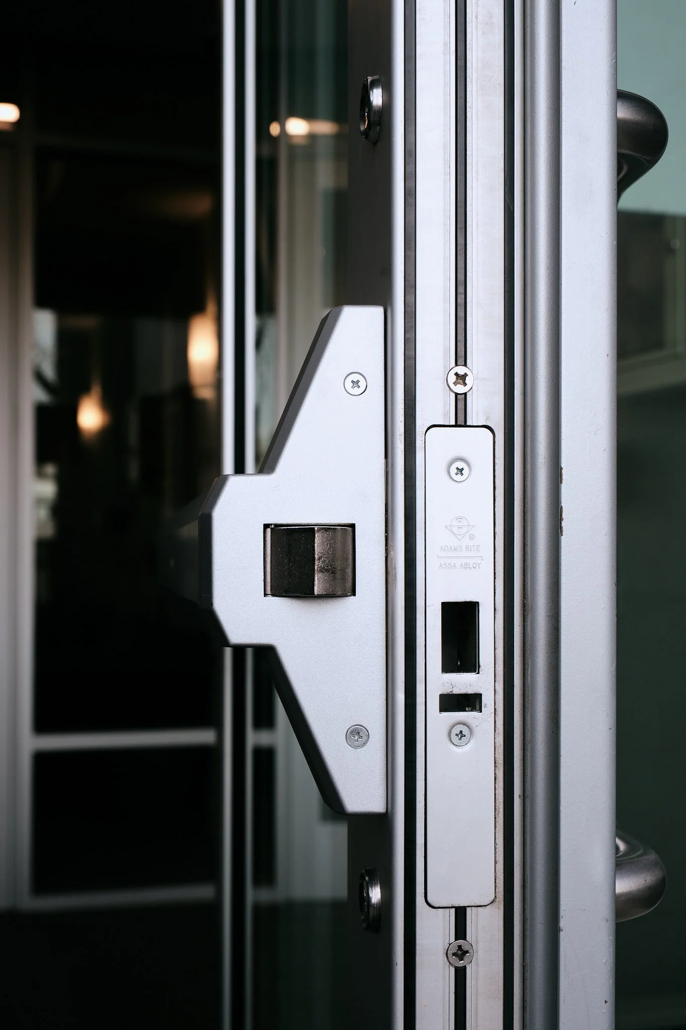 Close-up of a commercial door with metal frame and locking mechanism.
