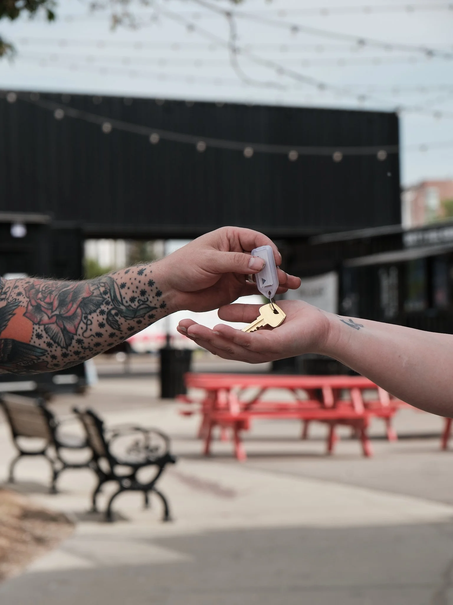Locksmith handing off freshly cut keys to a property manager.