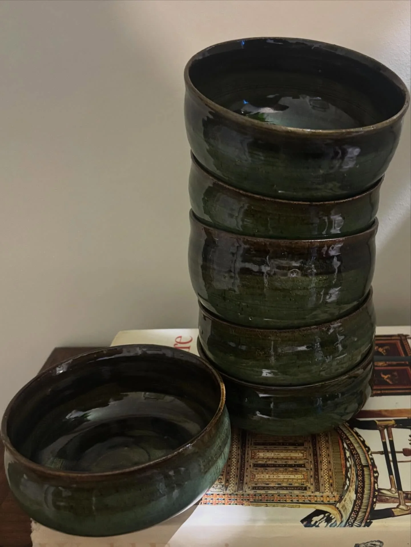 A tower of bowls with black slip and green glaze. #pottery #ceramics #clay #ceramic #stonewarepottery