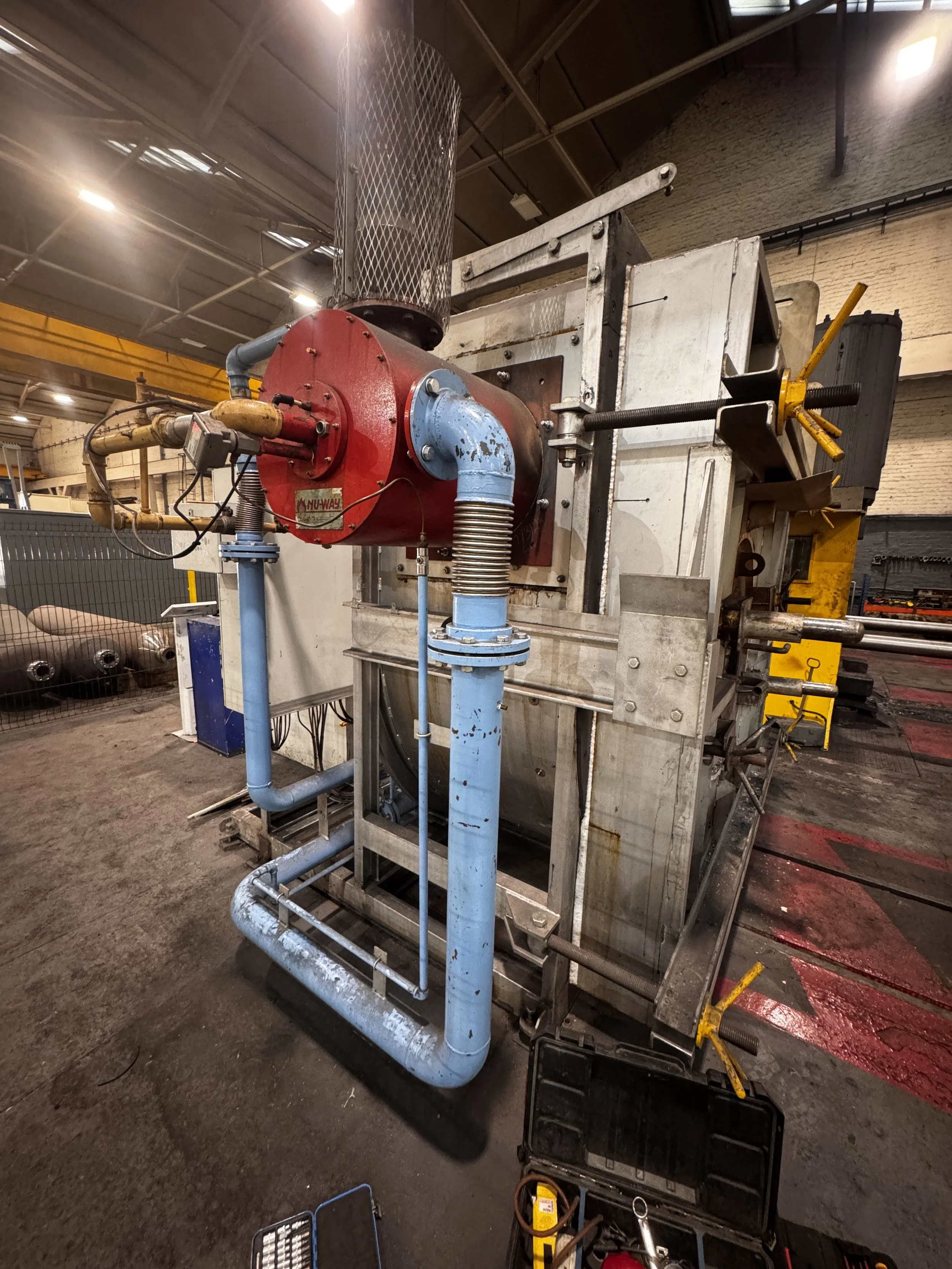 Industrial process heating furnace used in steel gas cylinder production.